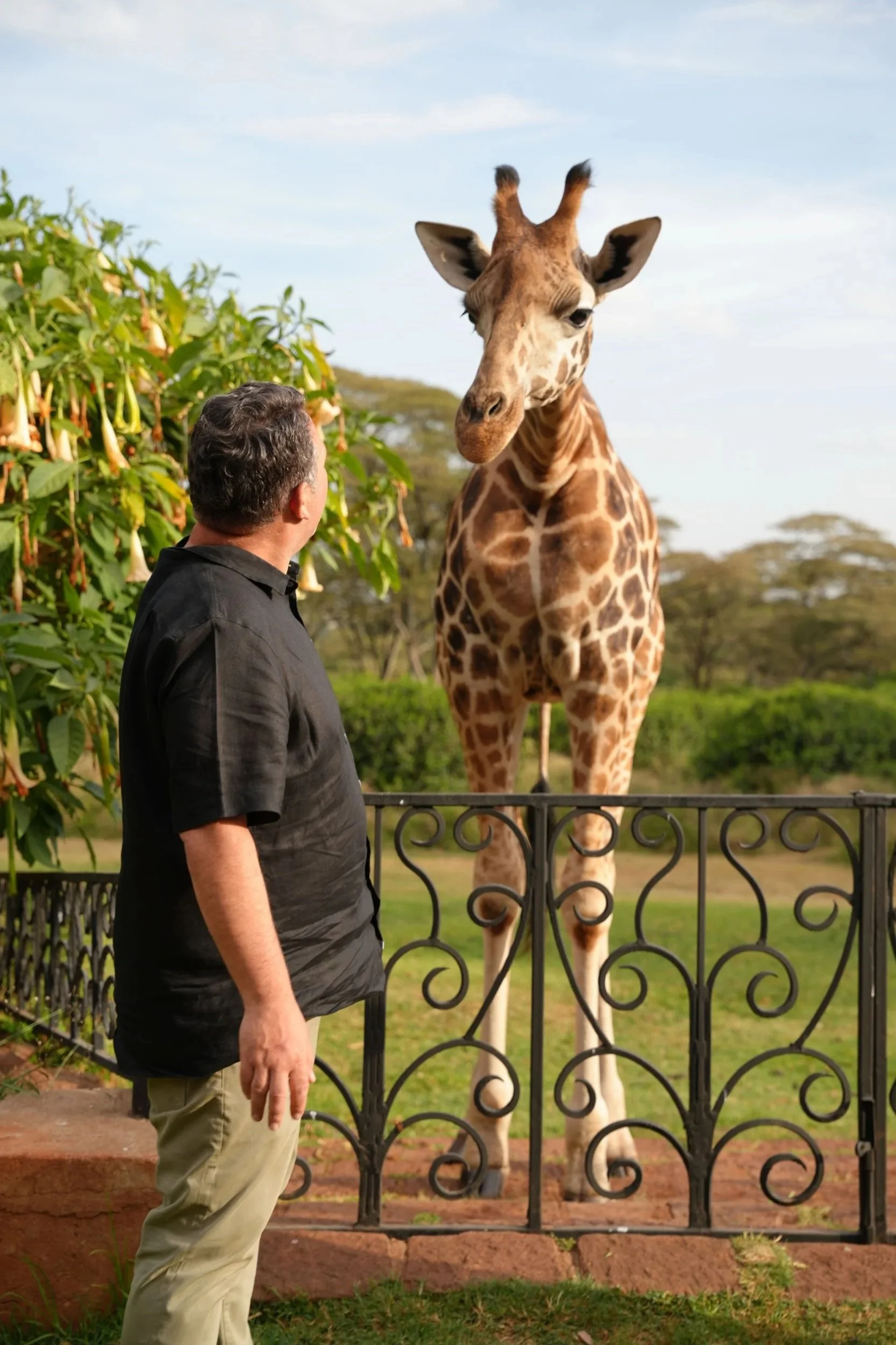 men with giraffe