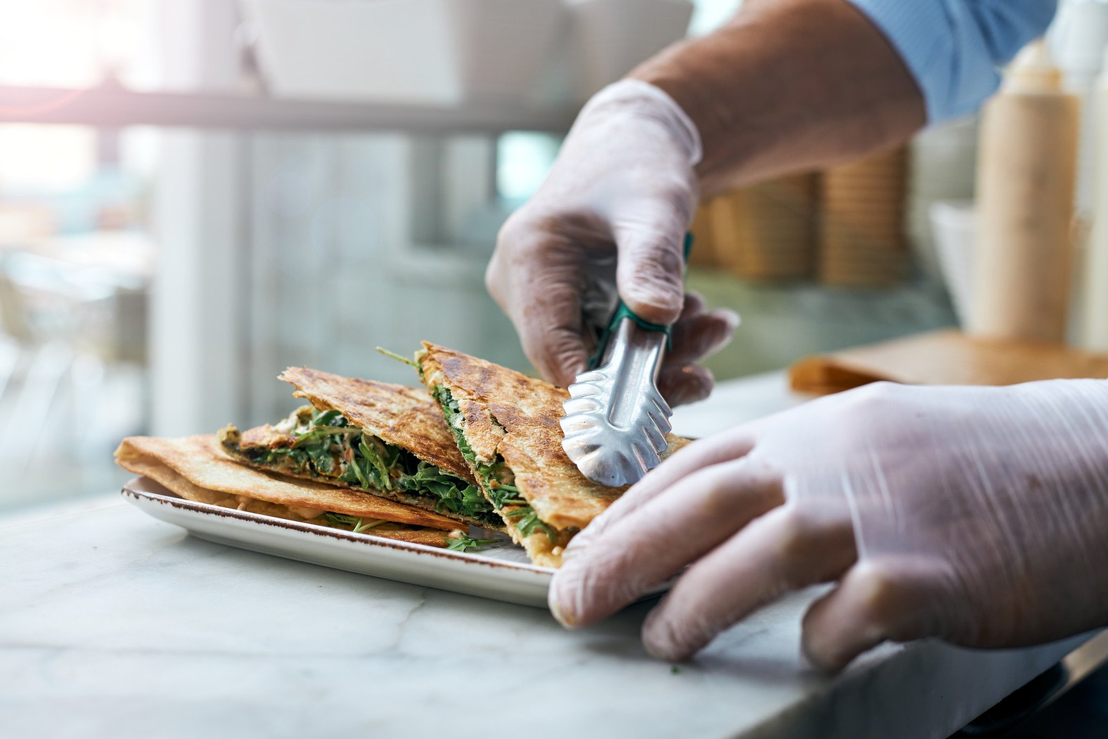 Piadina being placed on a plate
