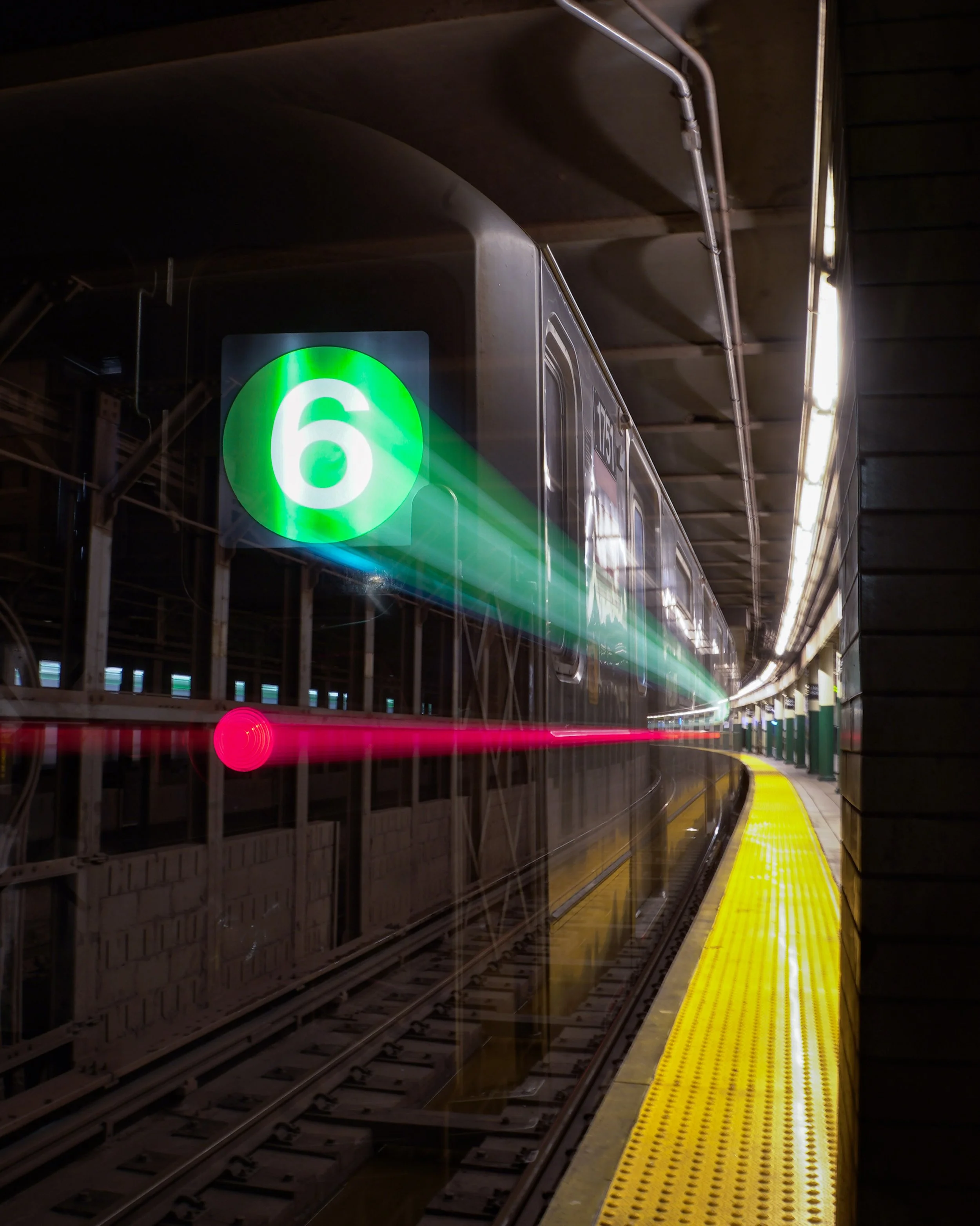 A subway train, number 6, is at a station platform with yellow safety edging, and light trails indicating motion inside the tunnel.