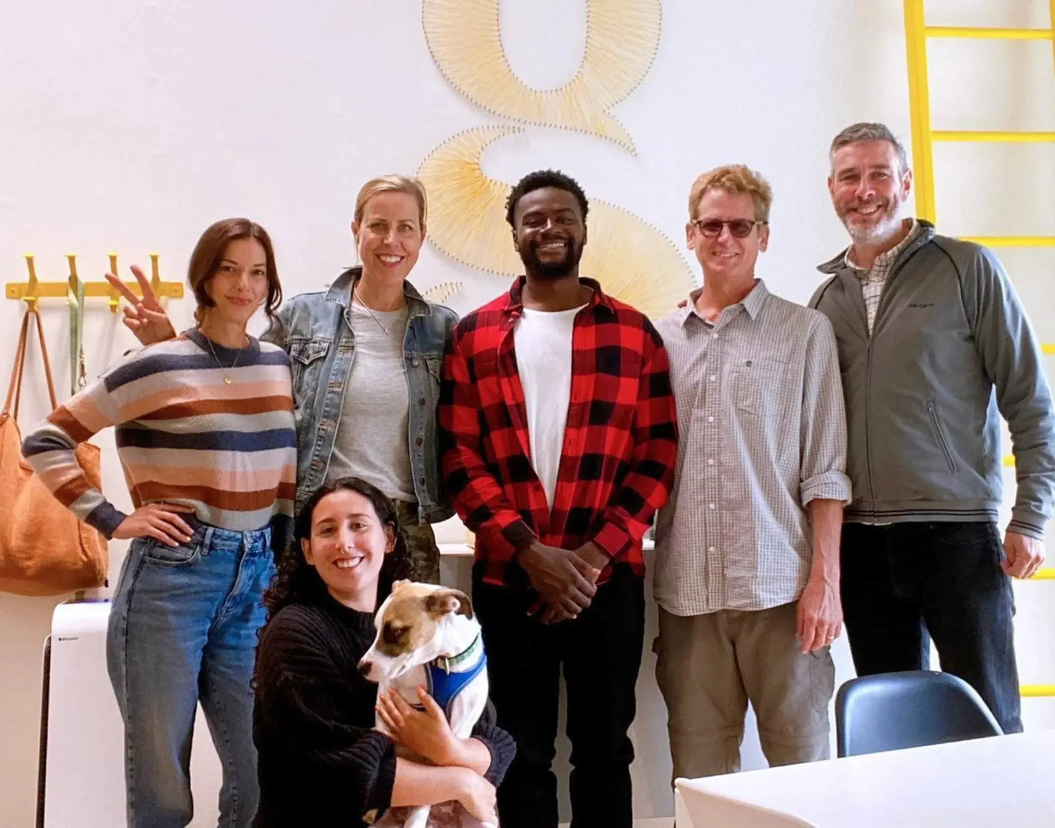 The Good Stuff Partners team poses for a photo with their intern.
