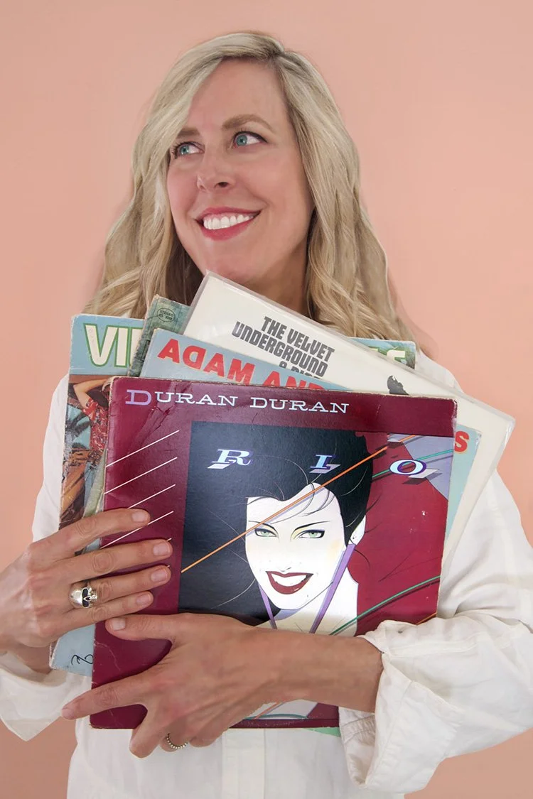 Aimee Kilmer holding vinyl records