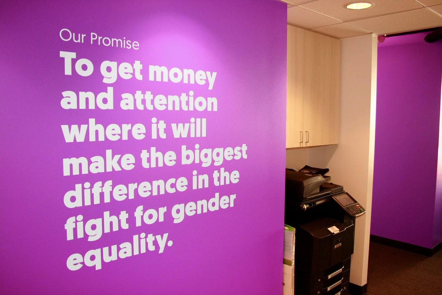 Global Fund for Women office branding "Our Promise" on wall