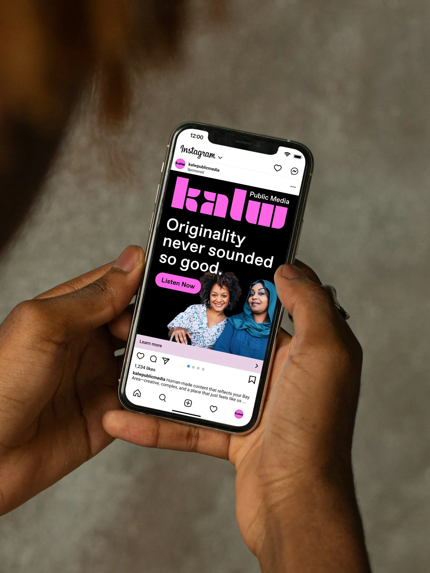 Hand holding phone, looking at Instagram KALW Public Media ad pictures two women smiling, reads "Originality never sounded so good. Learn more."