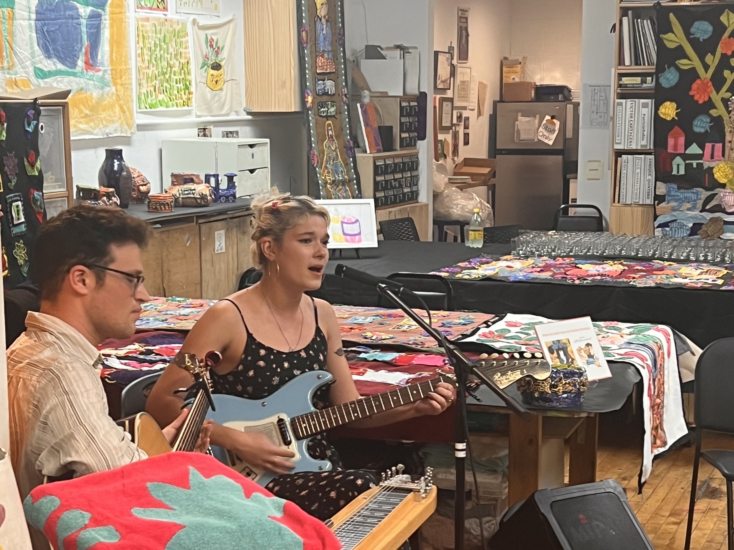 2 people playing instruments and singing at Creativity Explored event in San Francisco