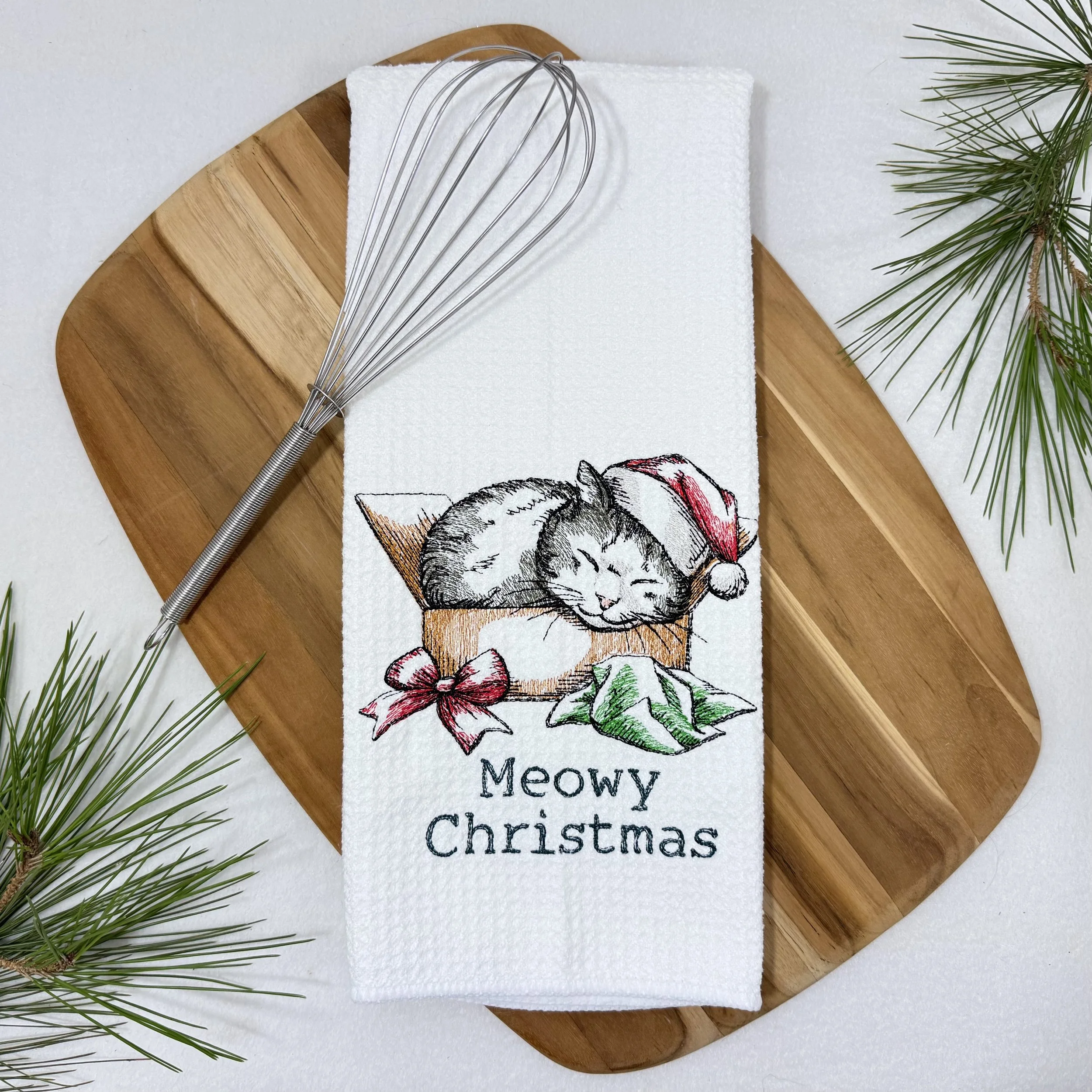Meowy Christmas Present embroidered microfiber kitchen and hand Christmas towel flat lay with greenery and kitchen tools