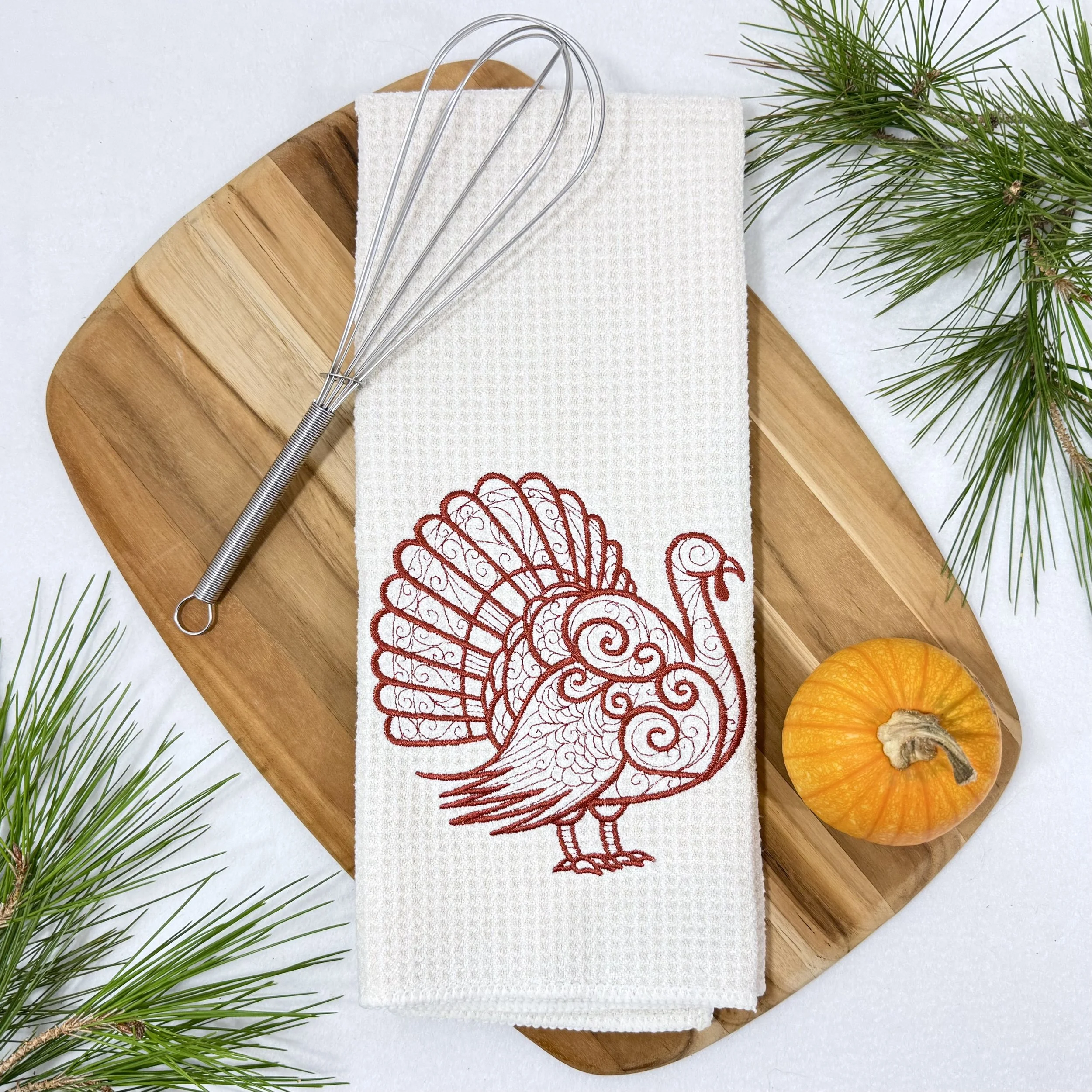 Turkey embroidered microfiber kitchen and hand towel flat lay with greenery, kitchen tool, and pumpkin