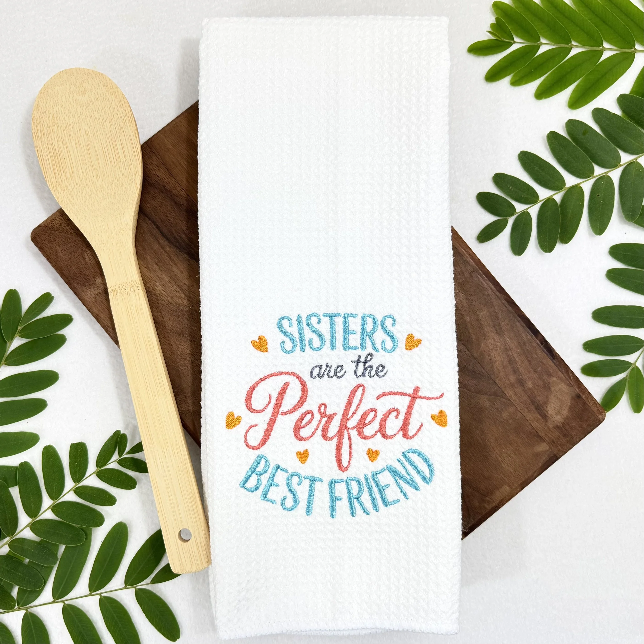 Sisters Are The Perfect Best Friend embroidered microfiber kitchen and hand towel flat lay with greenery and wood spoon