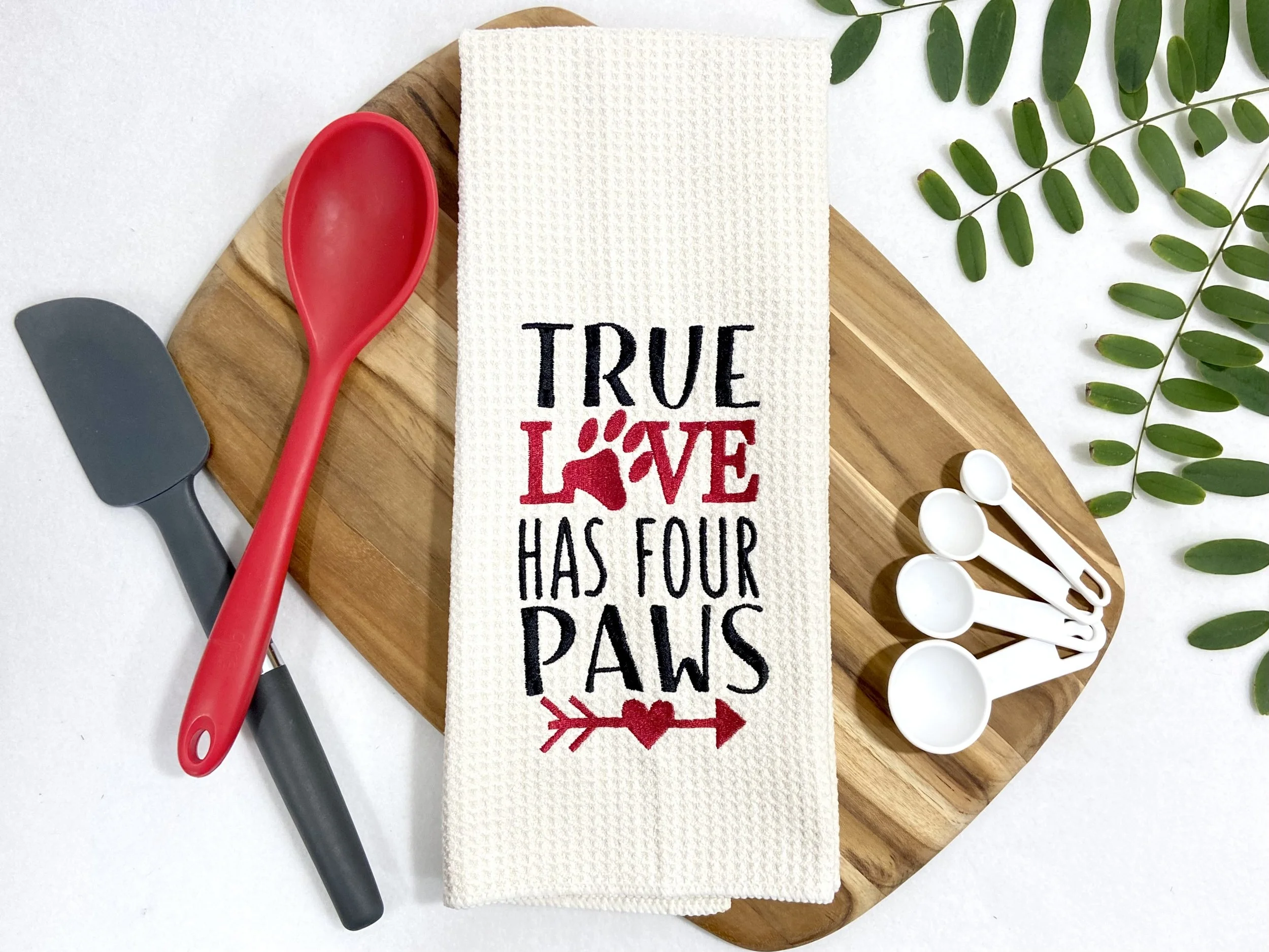 True Love Has Four Paws embroidered microfiber kitchen and hand towel flat lay with kitchen utensils, cutting board and greenery