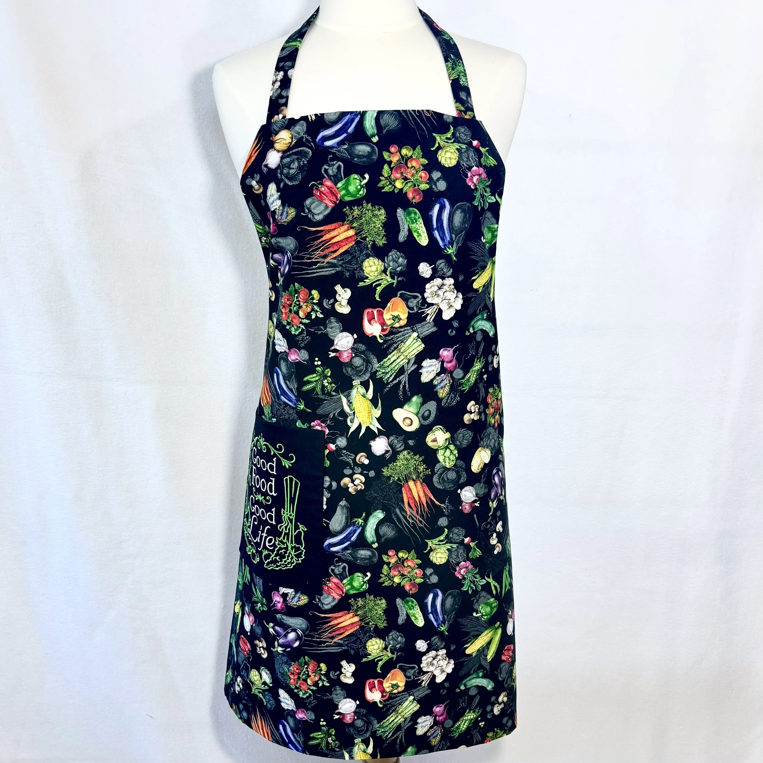 Front view apron with vivid garden vegetable print on black cotton