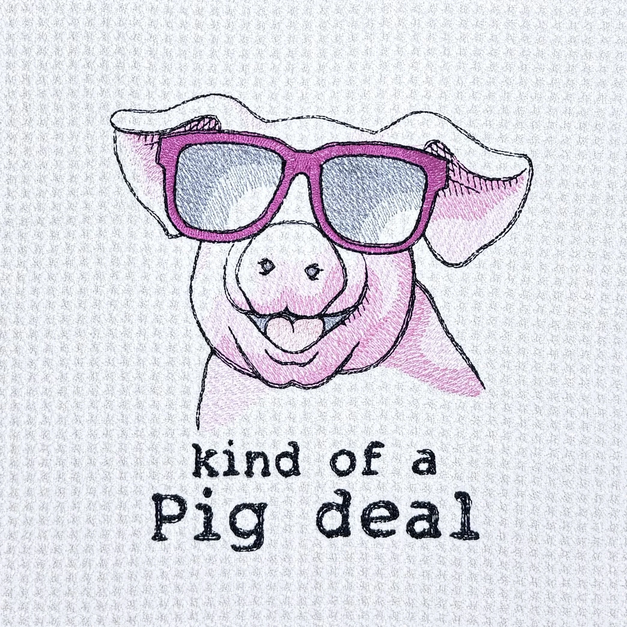 Close-up of Kind of a Pig Deal embroidery on microfiber kitchen and hand towel, showing detailed stitching and towel texture