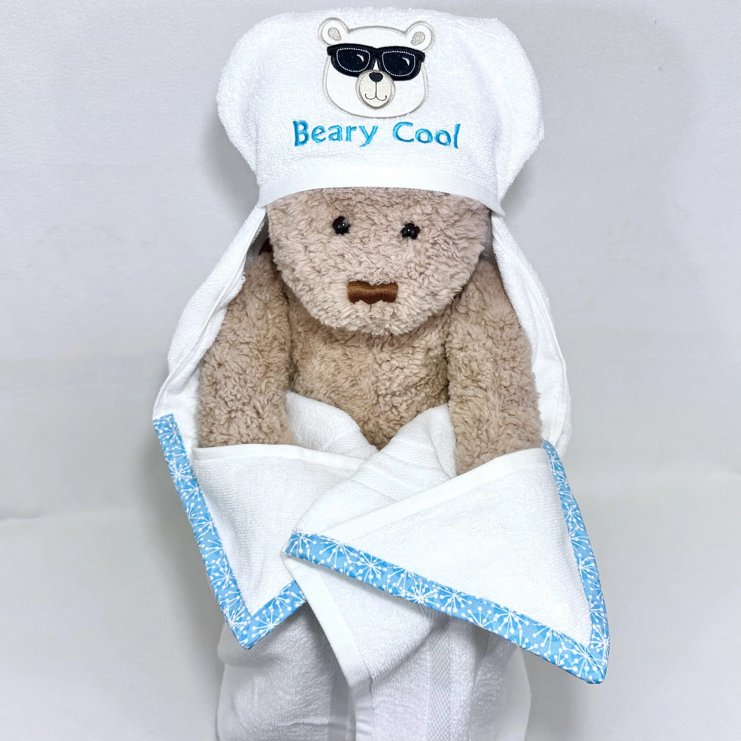Beary cool polar bear in sunglasses hooded towel displayed on a teddy bear to show full size and drape when worn by a child