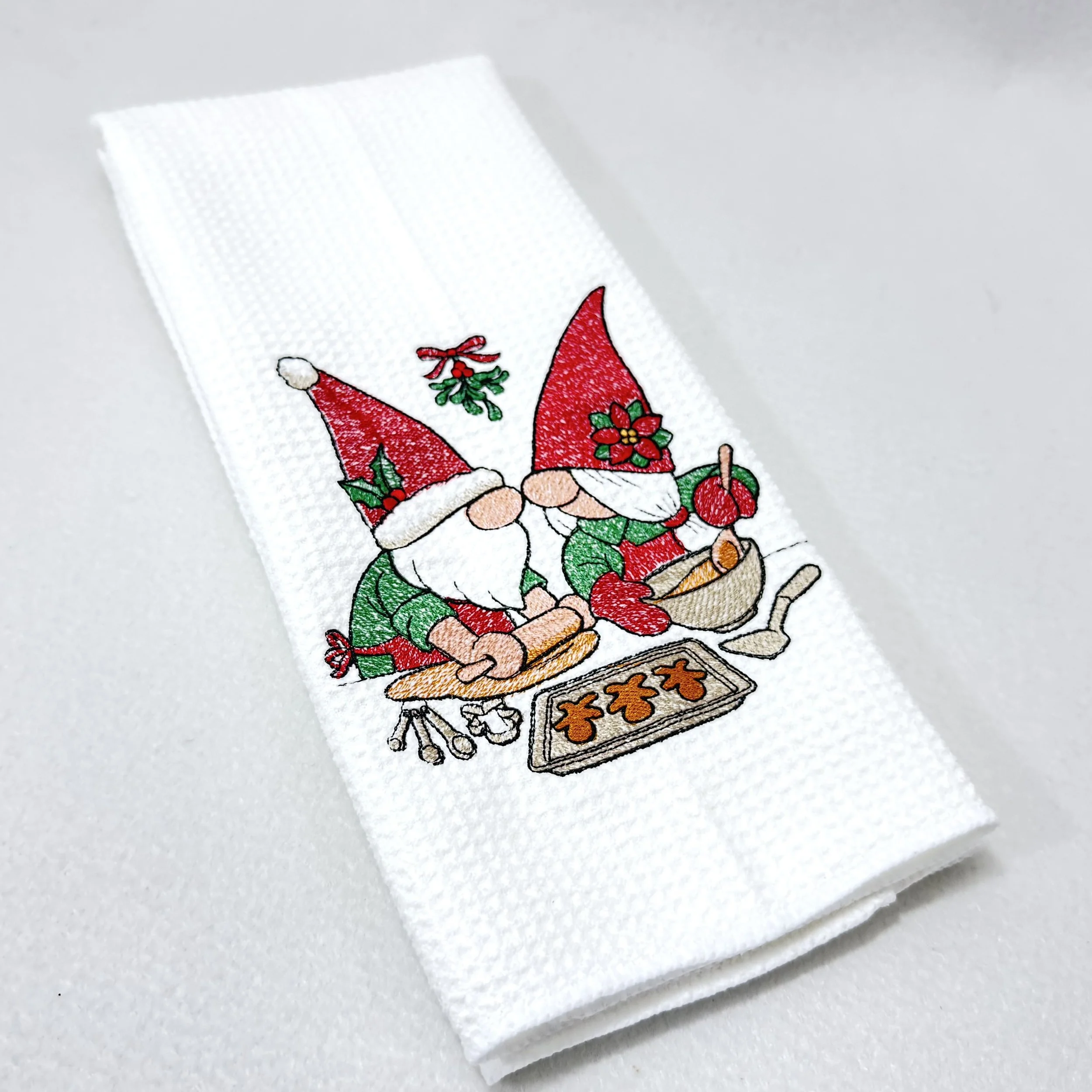 Christmas Gnomes Baking embroidered microfiber kitchen and hand Christmas towel folded on white background, showing design and texture