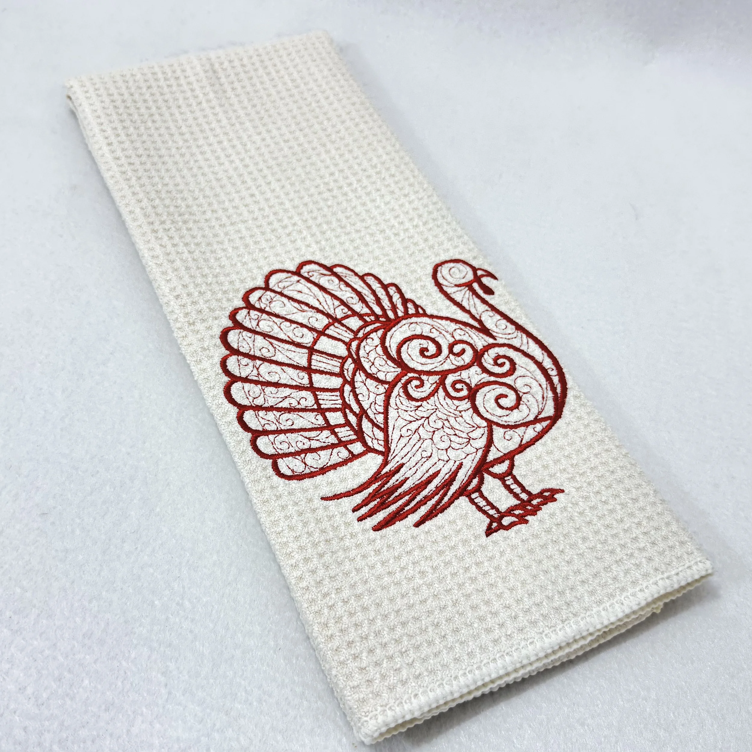 Turkey embroidered microfiber kitchen and hand towel folded on white background, showing design and texture