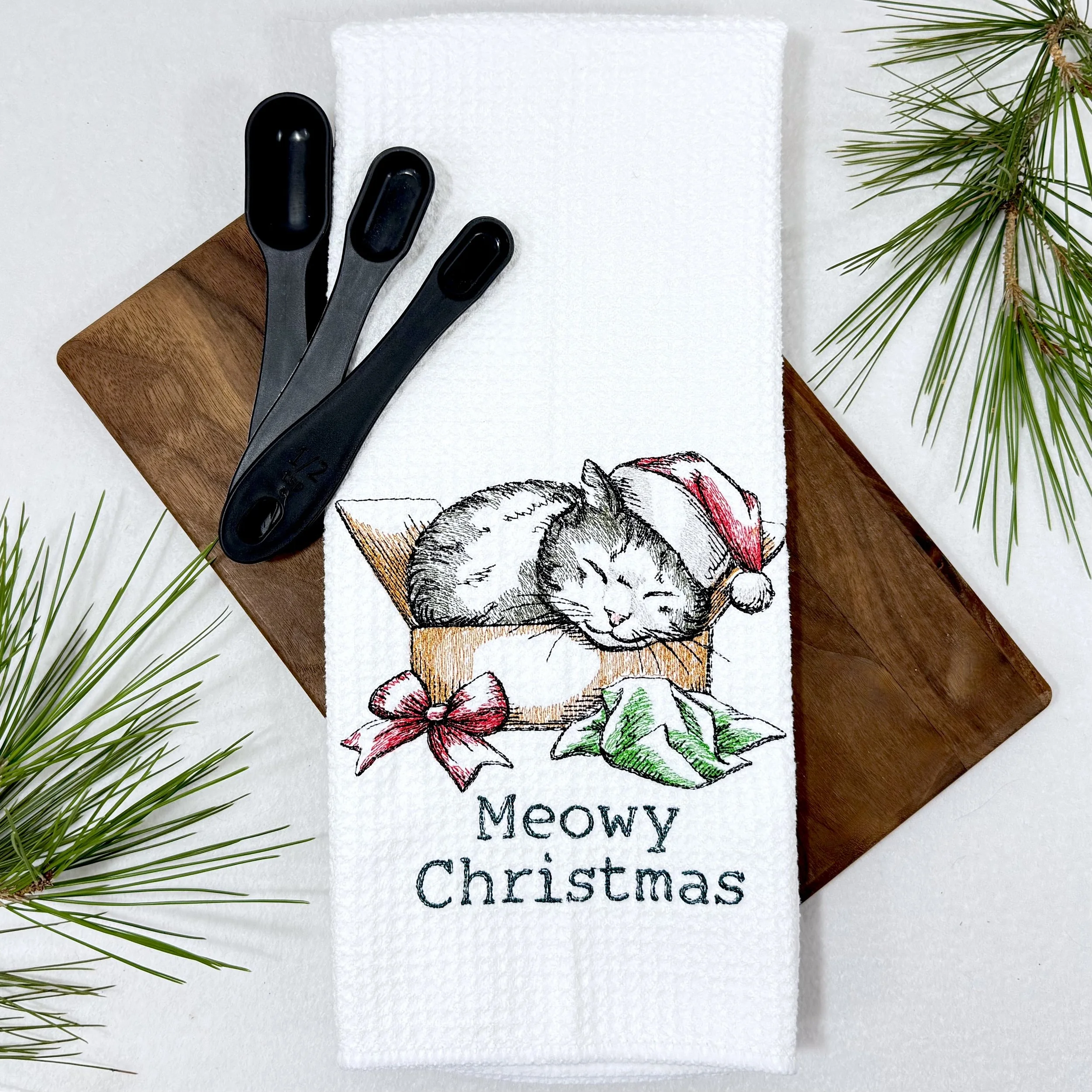 Meowy Christmas Present embroidered microfiber kitchen and hand Christmas towel flat lay with greenery and kitchen tools