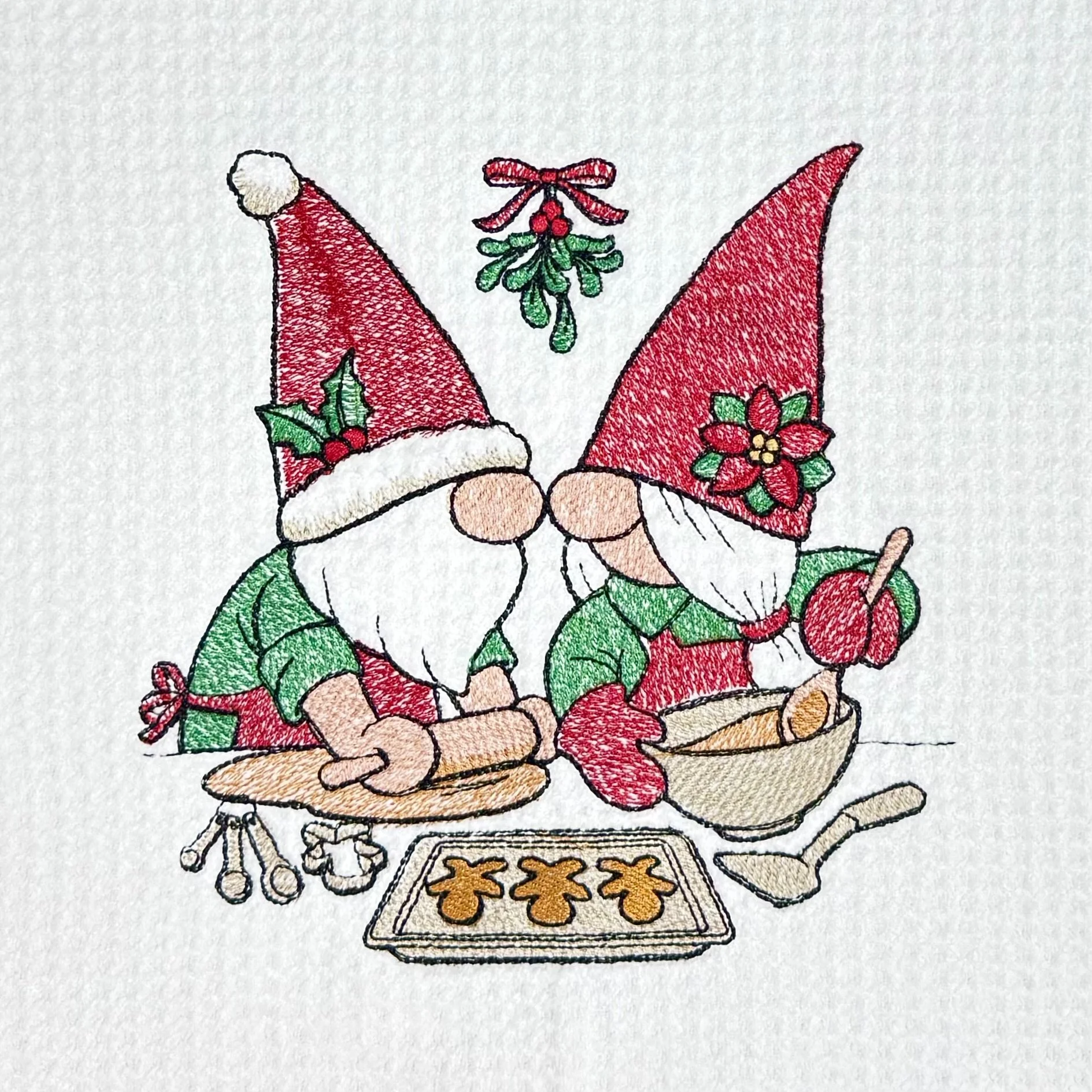 Close-up of Christmas Gnomes Baking embroidery on microfiber kitchen and hand Christmas towel, showing detailed stitching and towel texture