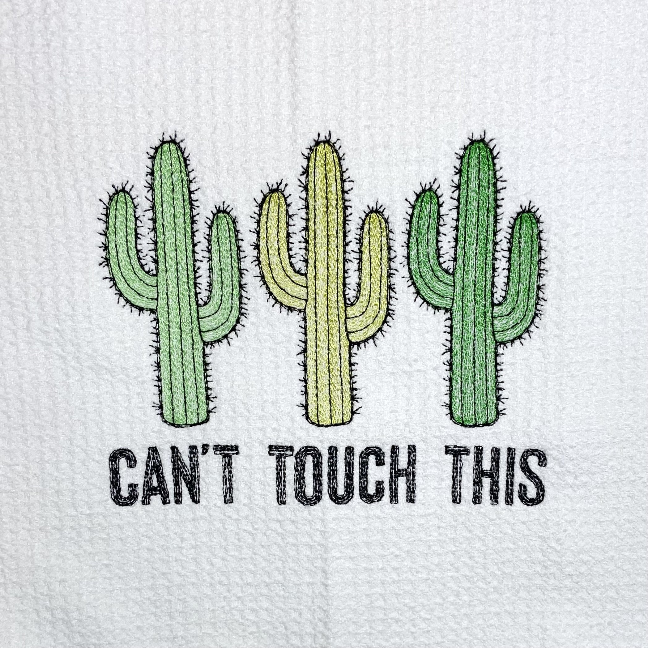 Close-up of green and yellow embroidered cactus stitching on microfiber towel