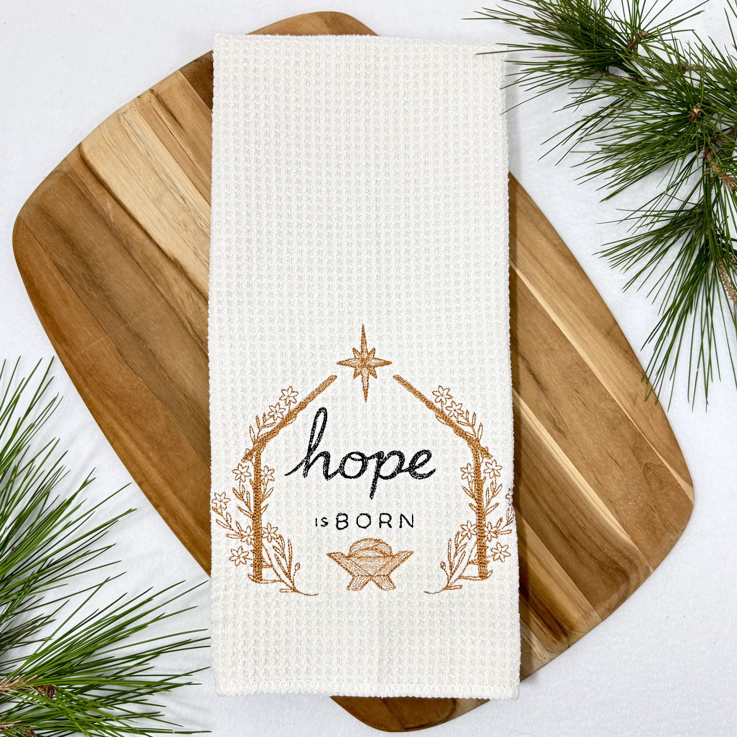 Hope is Born embroidered microfiber kitchen and hand Christmas towel flat lay with greenery