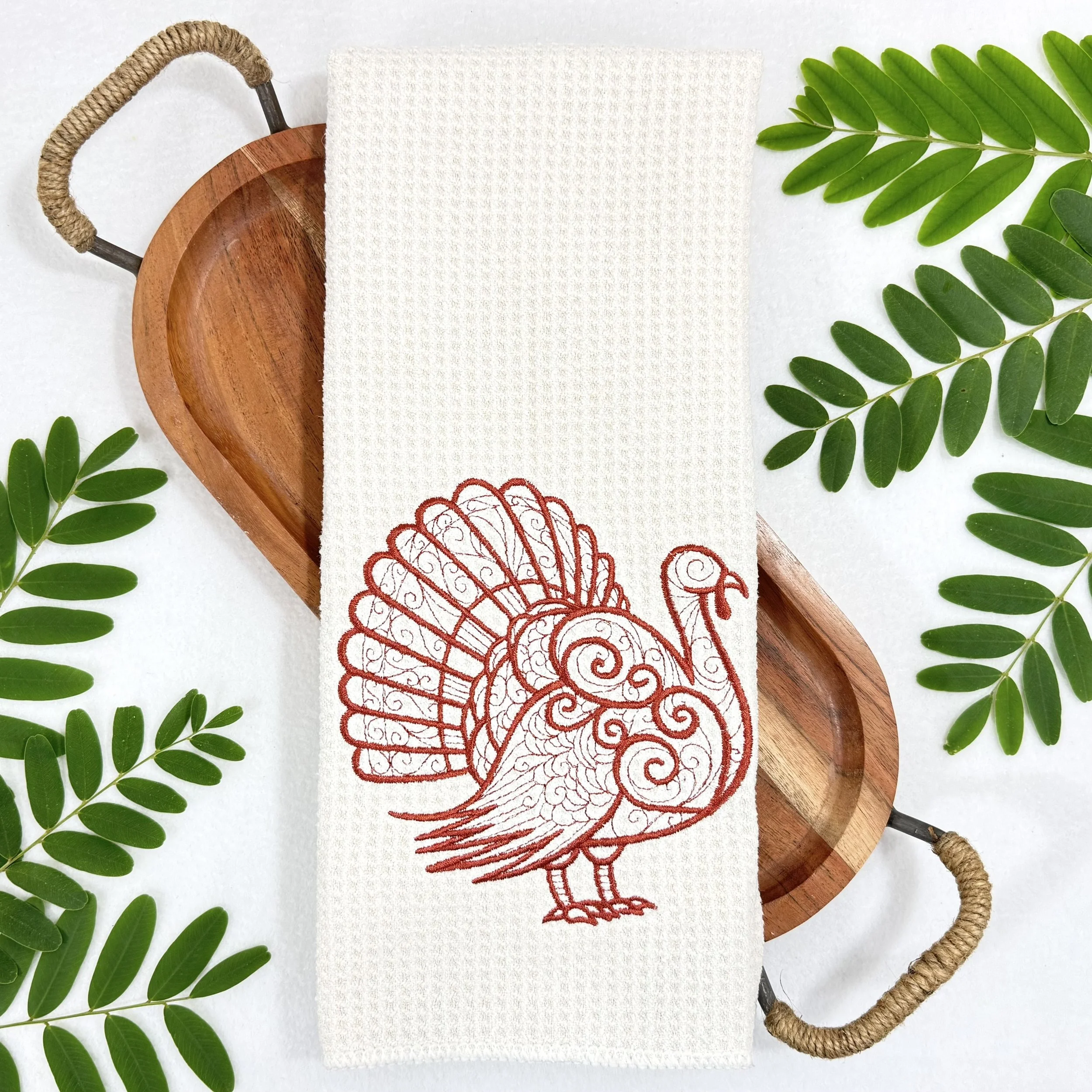Turkey embroidered microfiber kitchen and hand towel flat lay with greenery