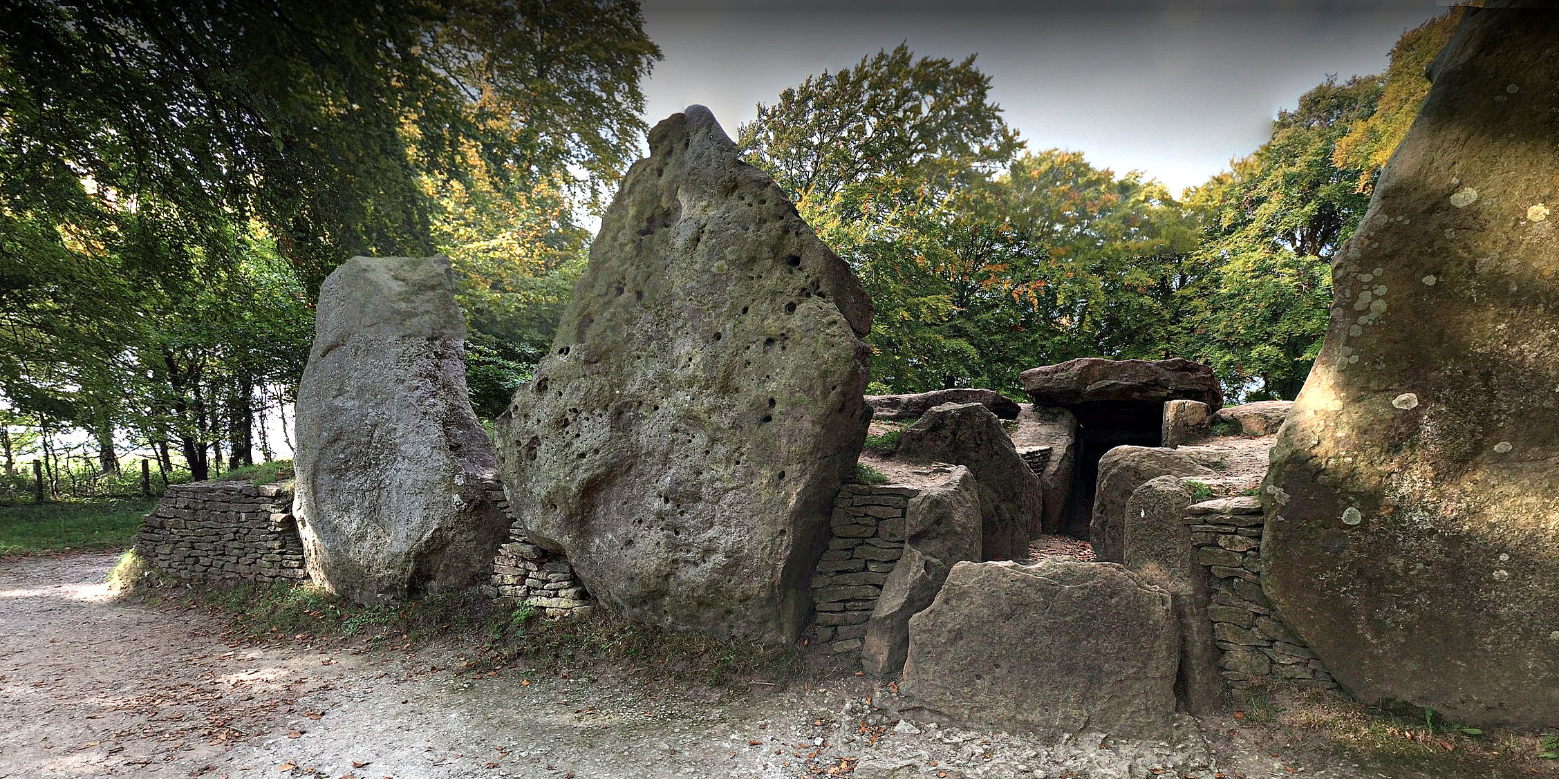  WAYLAN'S SMITHY  is a Neolithic burial and initiation site in Wiltshire, England. It includes a passage grave surrounded by a sacred grove of trees.