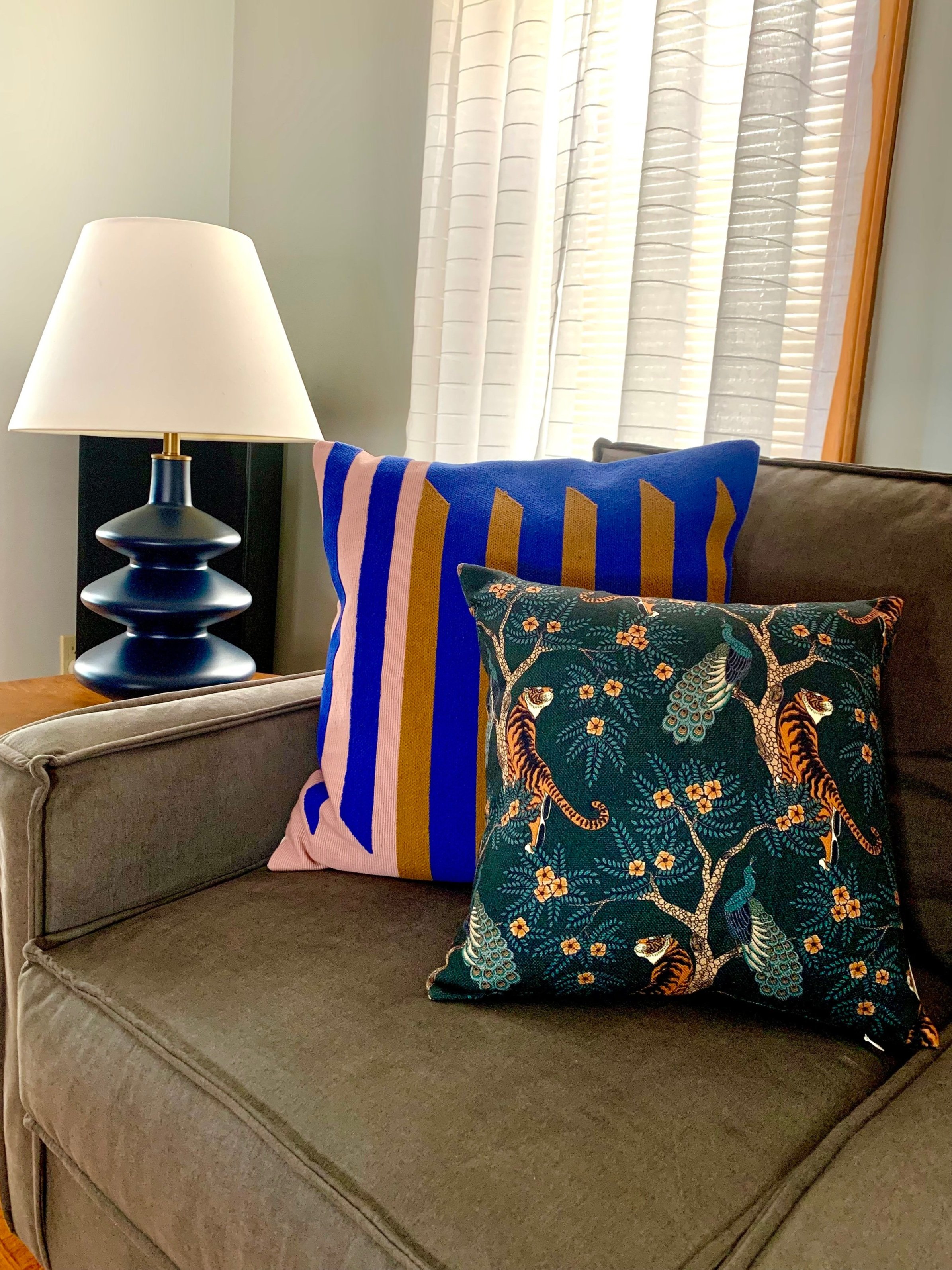 living room with colorful throw pillows and a decorative yet functional lamp, interior design by le terra curators