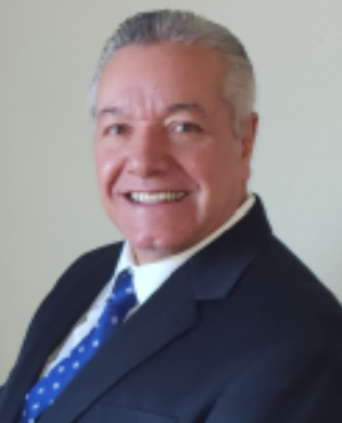 Smiling man in a suit and tie posing for a professional photo