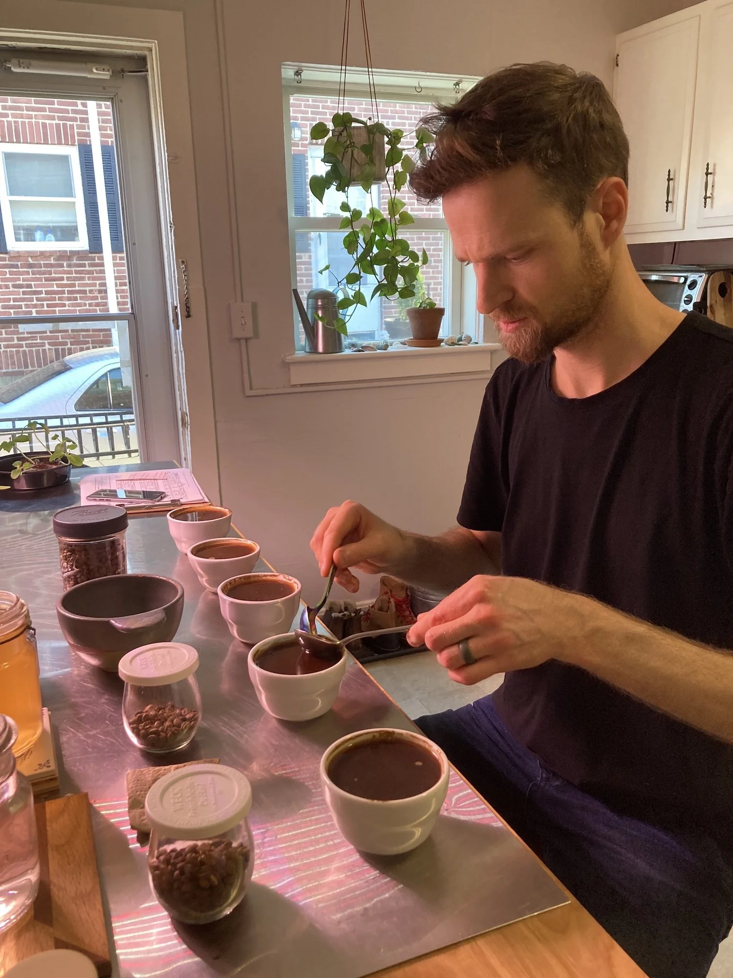 2021 – Evan cupping coffee samples in our kitchen.