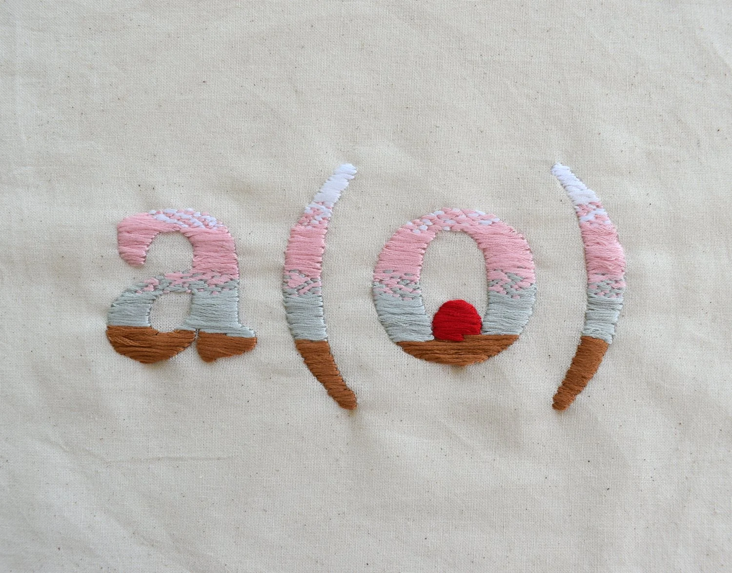 Cream fabric featuring a hand-embroidered "a(o)" logo in sunset-gradient colors, with a red circle inside the "o".