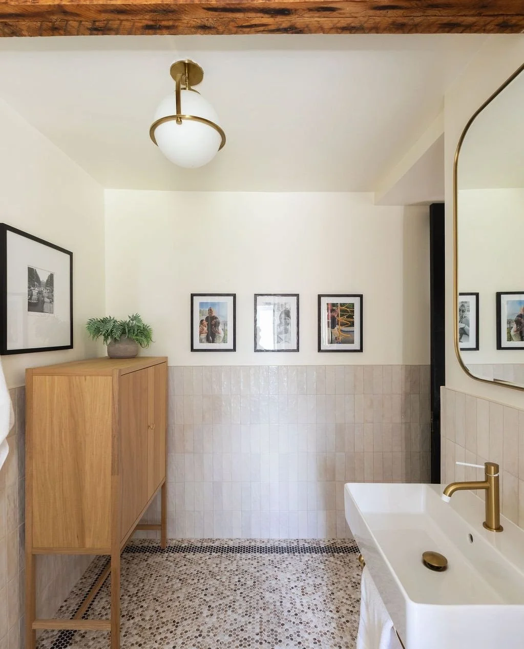 Another beautiful bathroom in the books. ✔️ ⁠
⁠
We love all of the unique choices this client made - custom tile work, thoughtful art, and warm finishes that accentuate the earthy exposed beams turned this space into a comforting home oasis.⁠
⁠
📸 @s