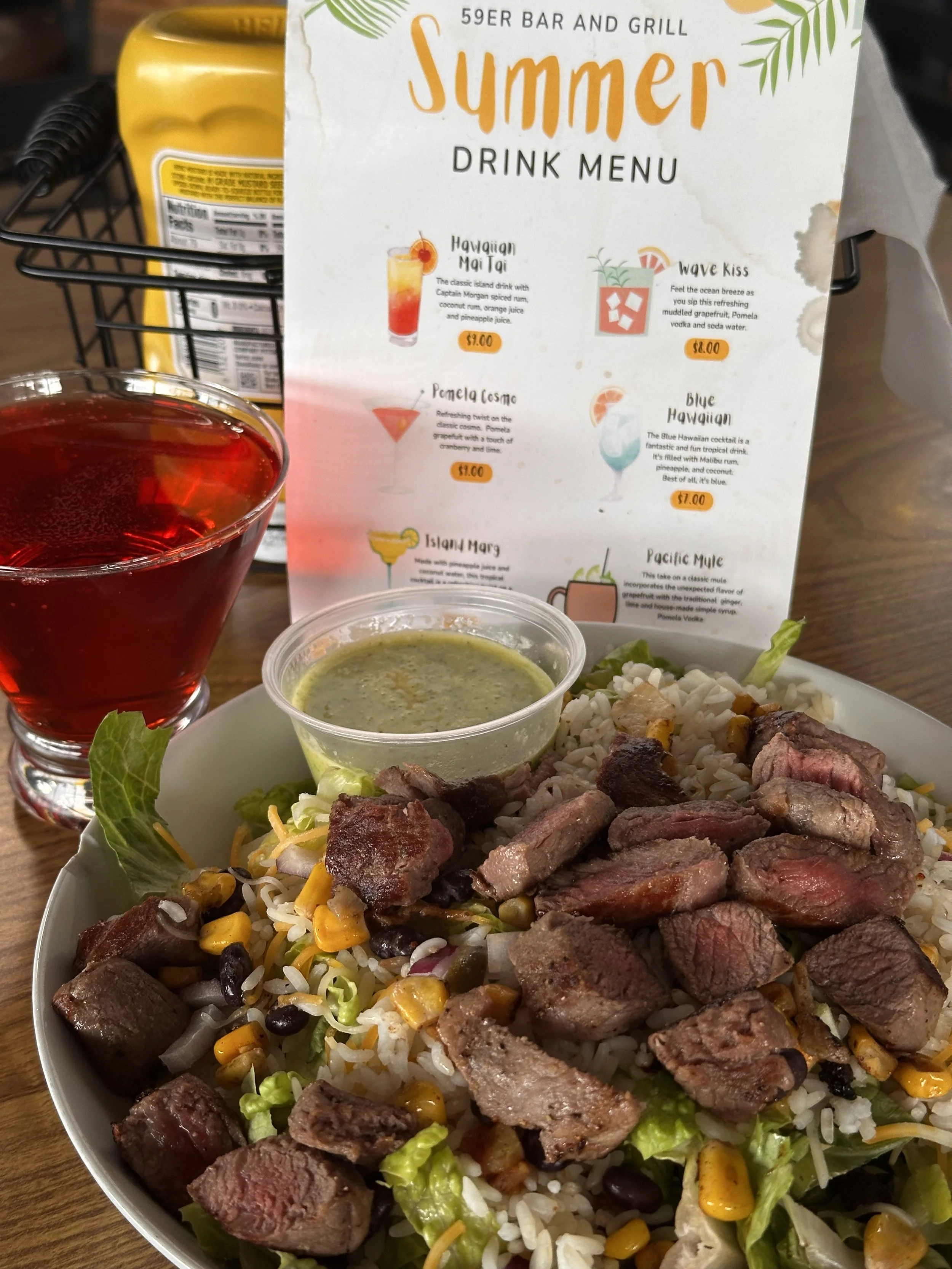 Beef Burrito Salad - lettuce, onion, grilled chicken, shredded cheddar cheese, rice, corn and black bean salsa, cilantro lime dressing