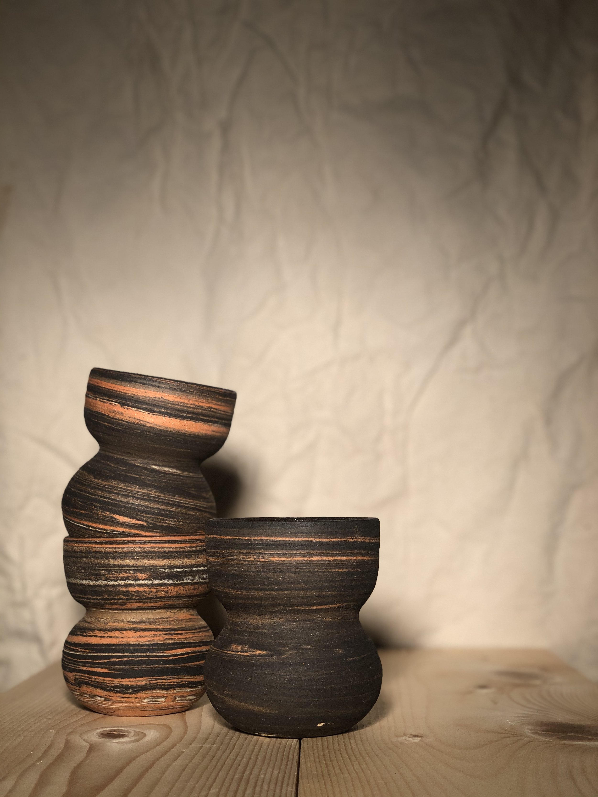 Egg shaped vase with yellow flowers inside