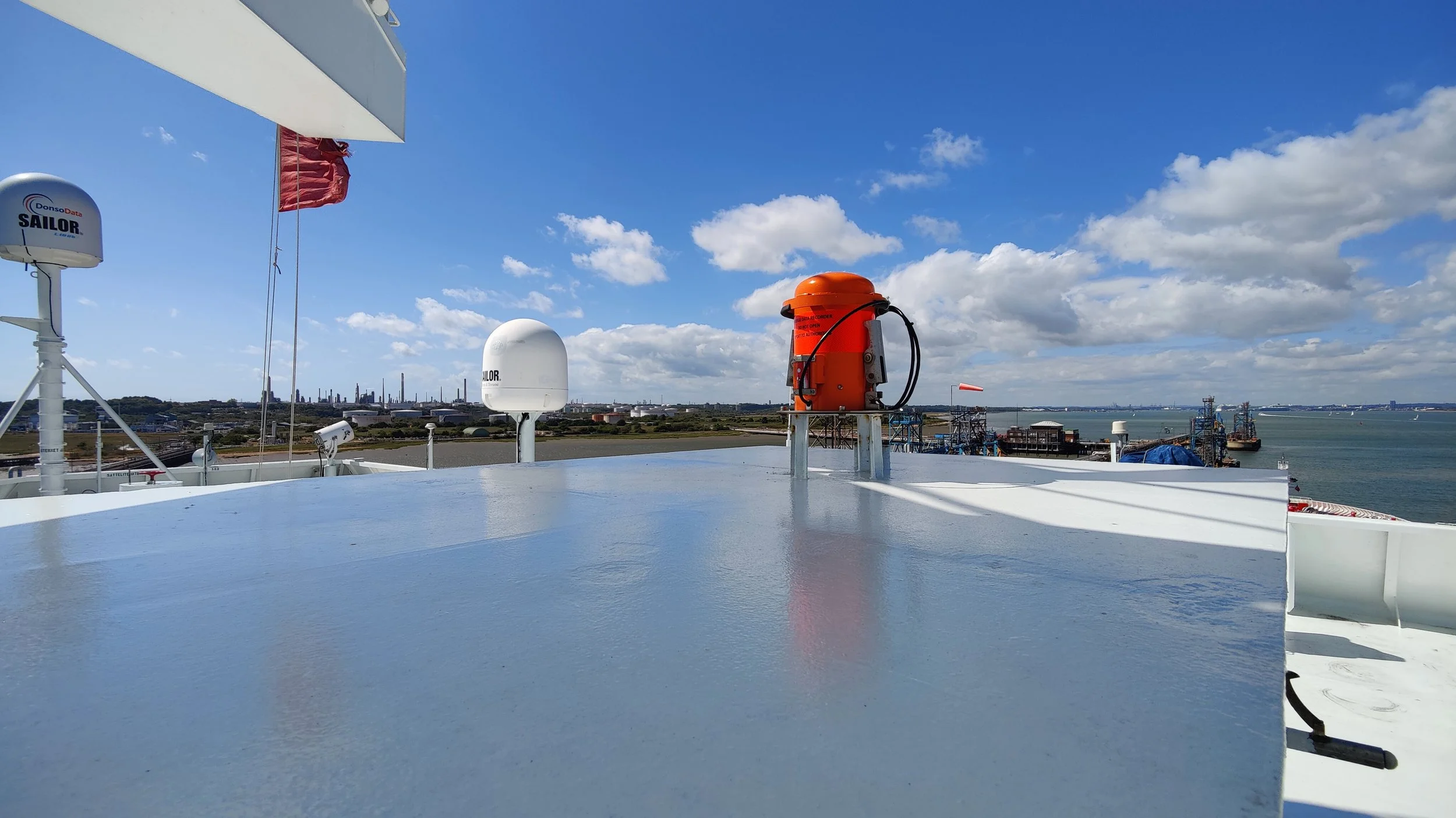 Ship’s roof with navigation antennas and safety equipment overlooking harbor — AVATEC Marine delivers advanced bridge electronics, communication, and safety solutions for vessels worldwide.