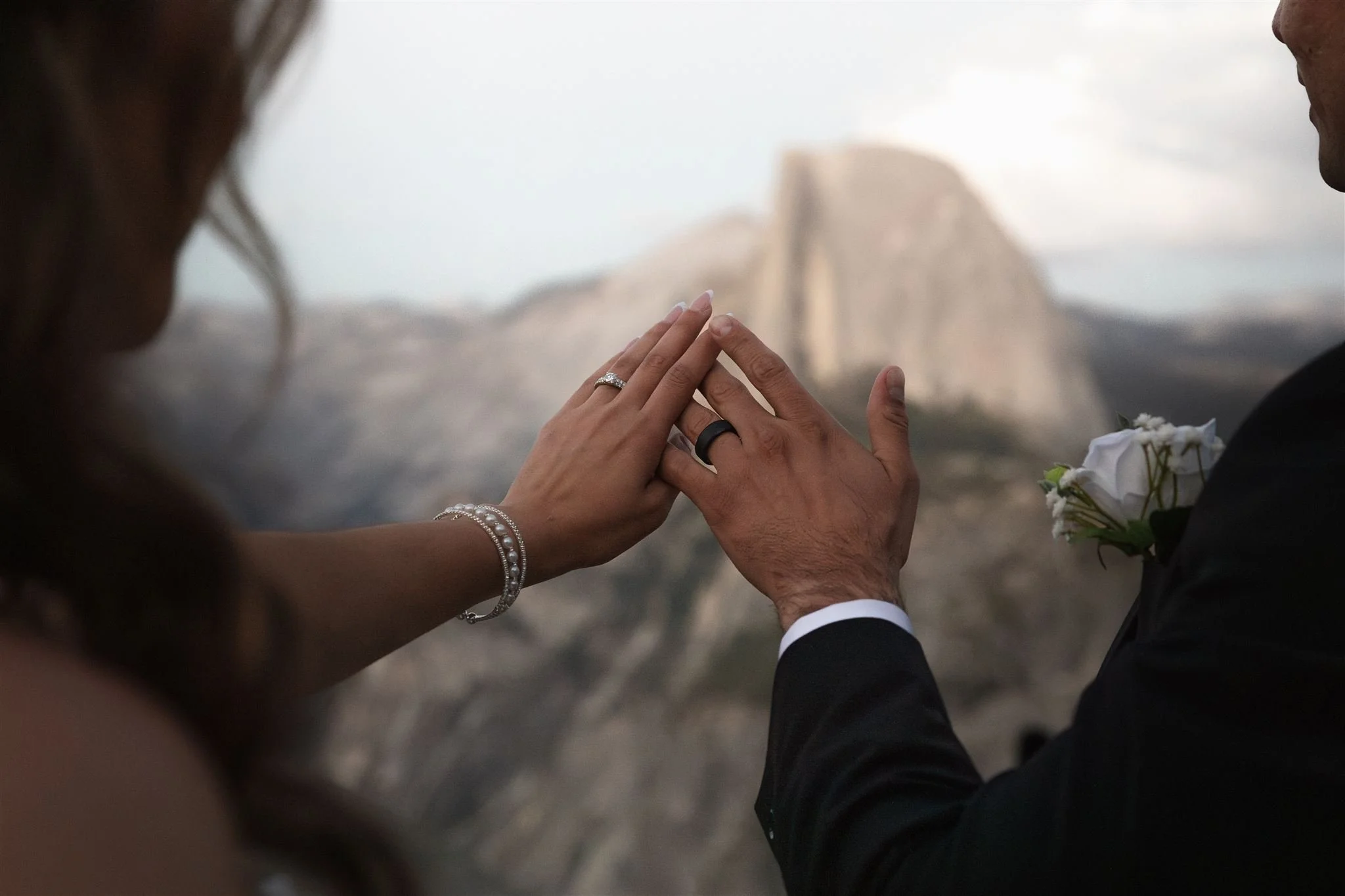 Couple puts their ring hands together to show their rings after their elopement ceremony in Yosemite