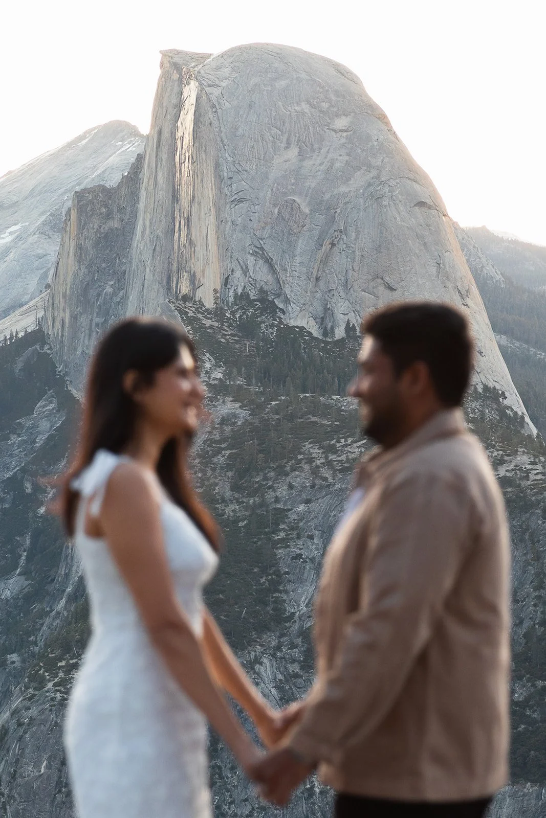 engagement session portrait with granite cliffs and pine trees at glacier point in California