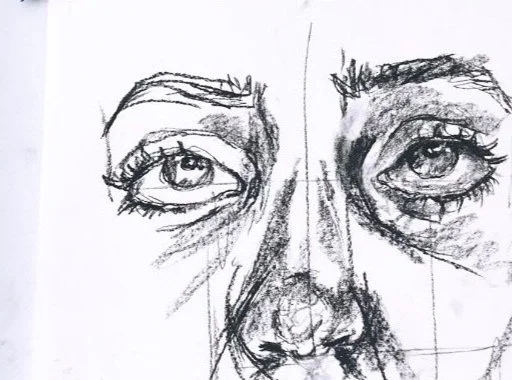 Sketch of a person's face, focusing on detailed eyes, nose, and eyebrows, with visible pencil strokes.