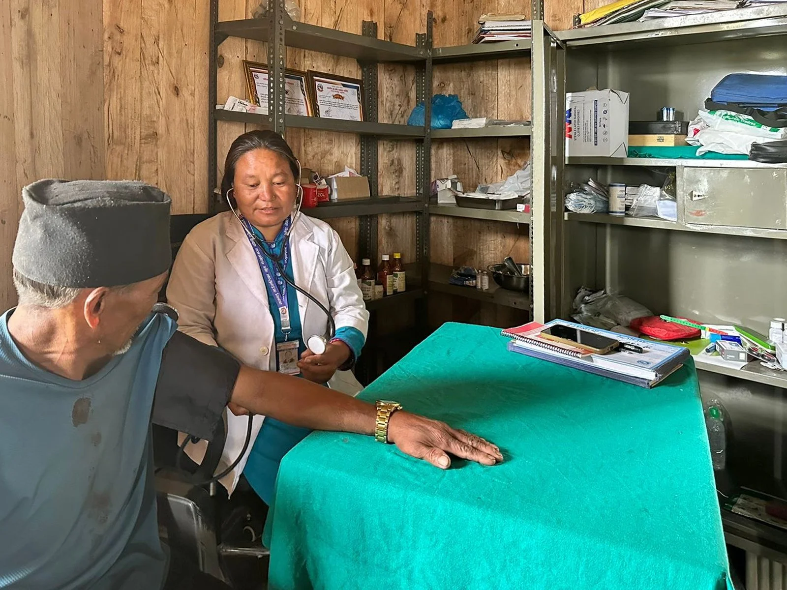Nurse Usha Rai takes the blood pressure of a villager in Ekuwa, Nepal using a manual blood pressure cuff.