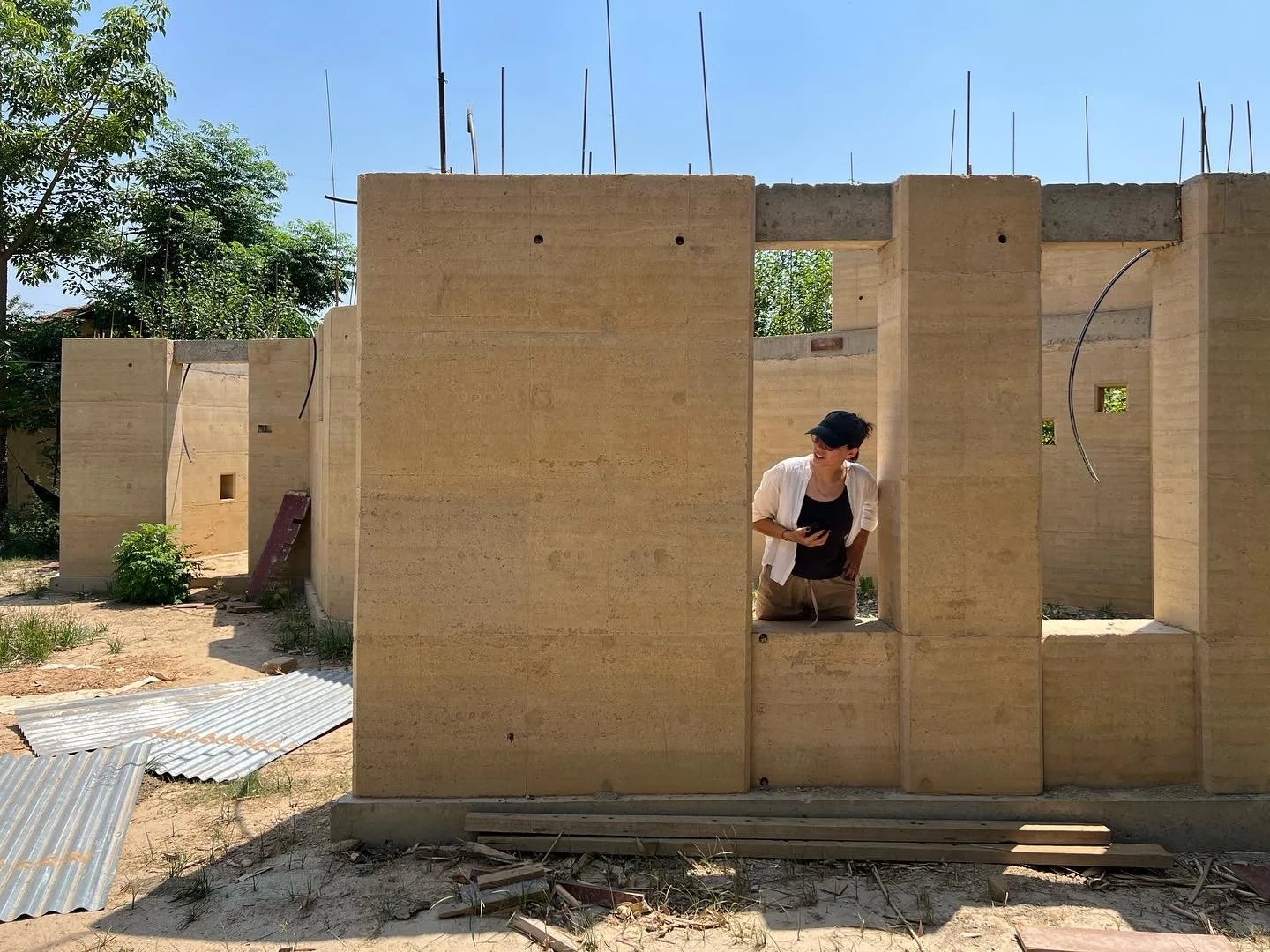 Building Bureau cofounder Anna Leshnick observes the rammed earth walls during construction of the Tiger Track Ecolodge in Bardiya, Nepal.