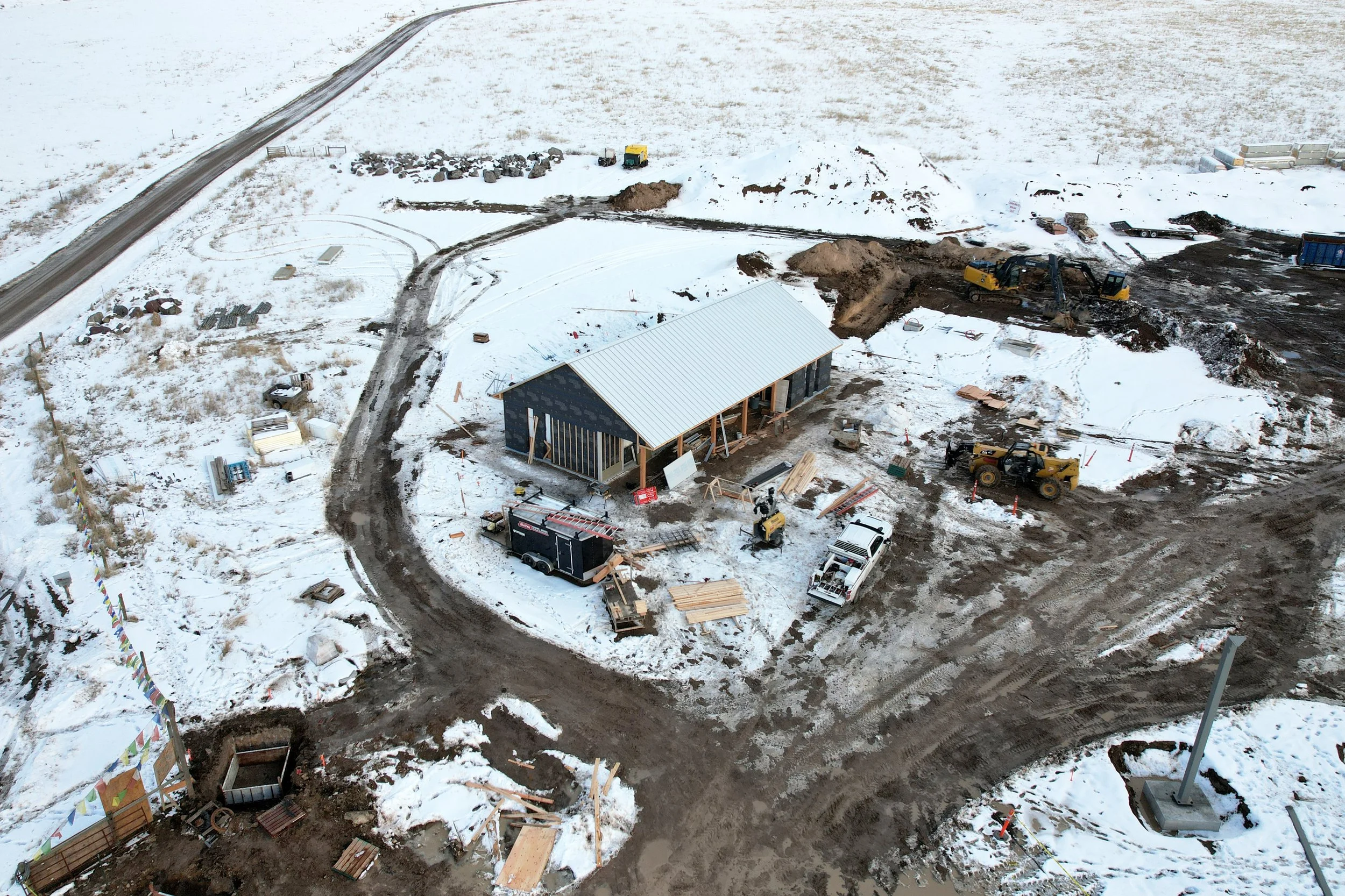 Snowy aerial view of the Welcome House under construction in rural Montana.