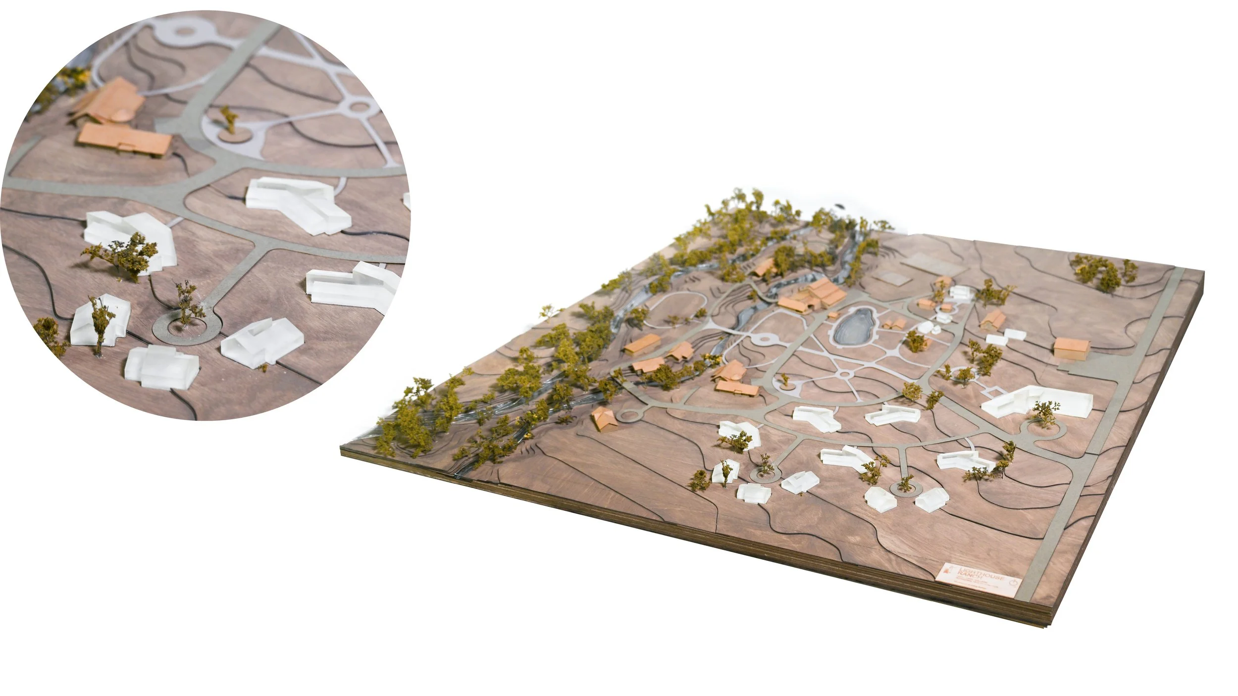 A detailed architectural model of the Lighthouse Ranch in Montana showing pathways, trees, and buildings.