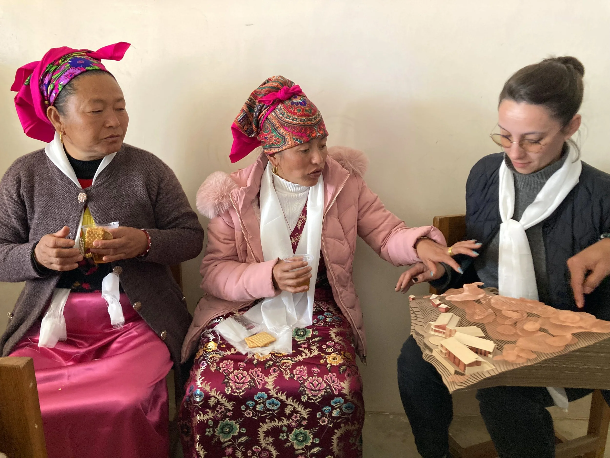 Building Bureau cofounder Anna Leshnick discusses the Helambu Hospital with villagers at a public meeting in Ichok, Nepal.