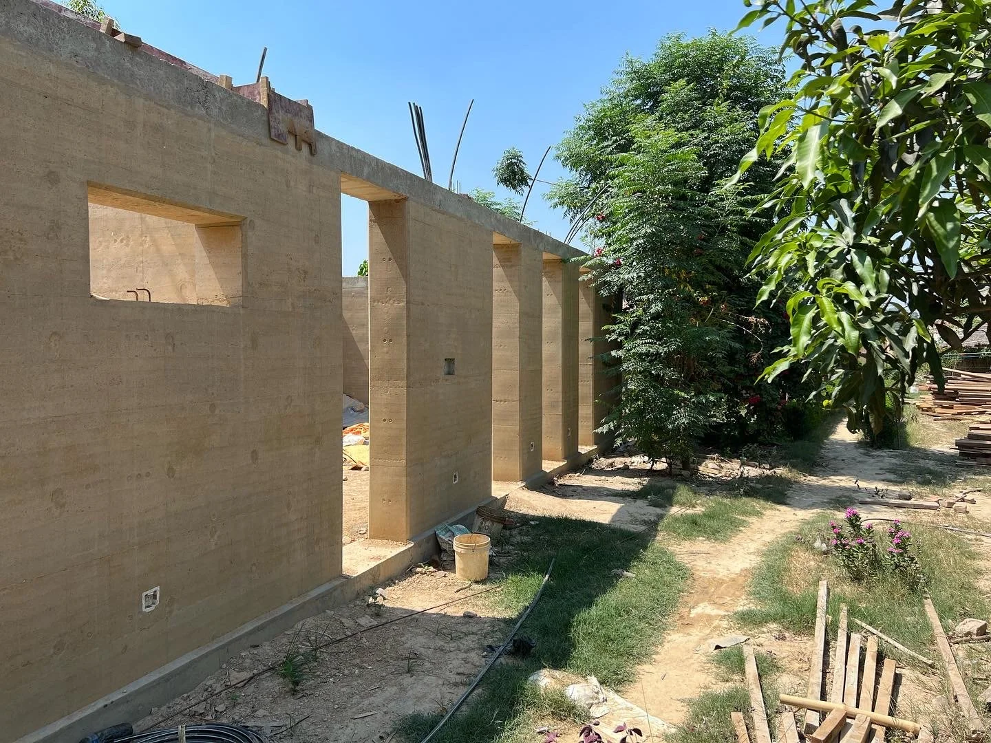 Construction of rammed earth walls for the Tiger Track Ecolodge in Nepal.
