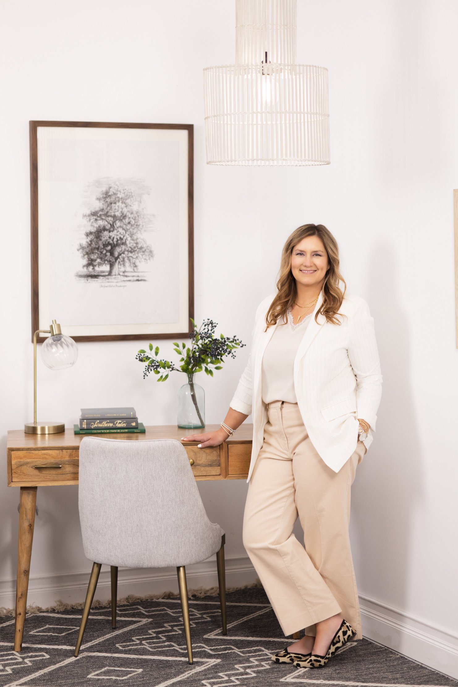 Woman leaning against desk and smiling,  lifestyle headshot by tammy brice in minneapolis