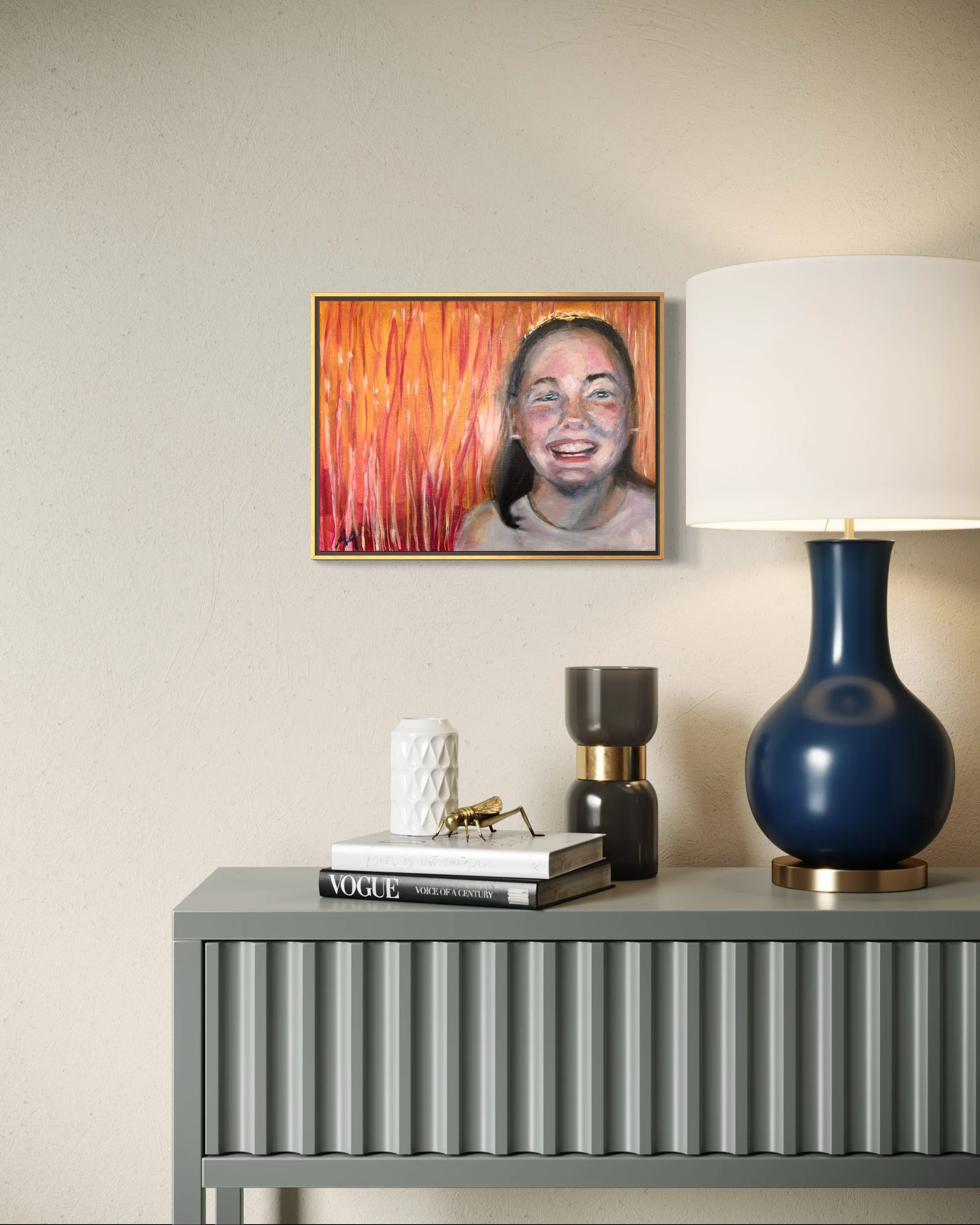 A framed portrait hanging above an entry table, capturing a radiant smile against a vibrant orange and pink backdrop evoking warmth and joy.