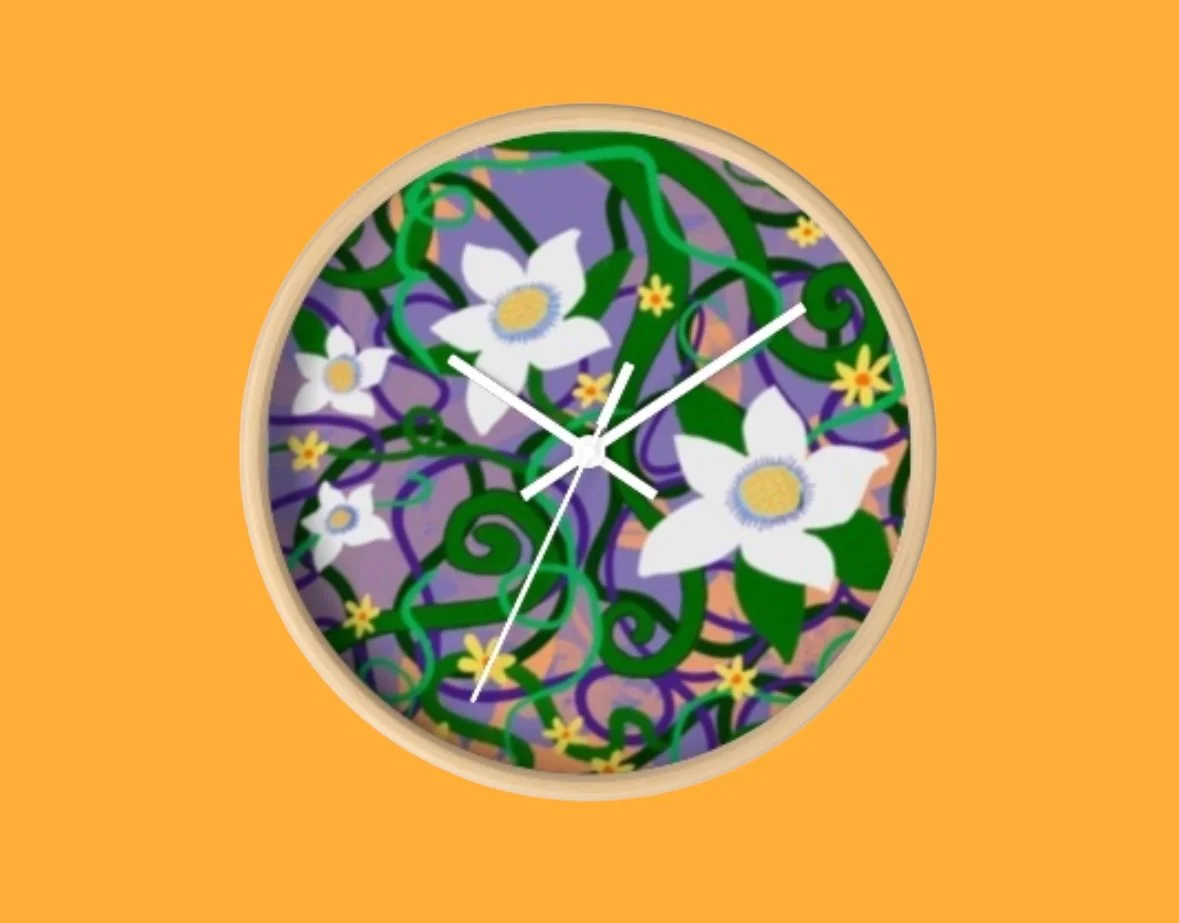 Round wall clock with a floral mosaic design featuring white flowers with yellow centers and green vines, set against a purple background.