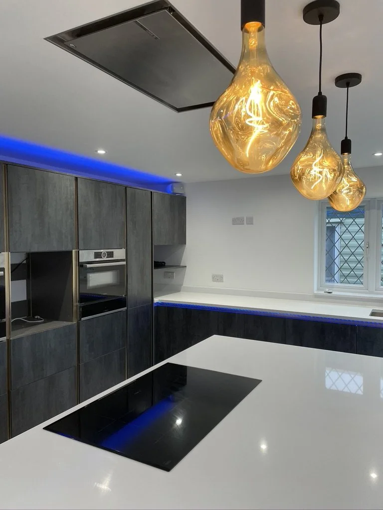 Modern kitchen with black induction cooktop, dark wood cabinets, pendant lighting, and a window with security bars.