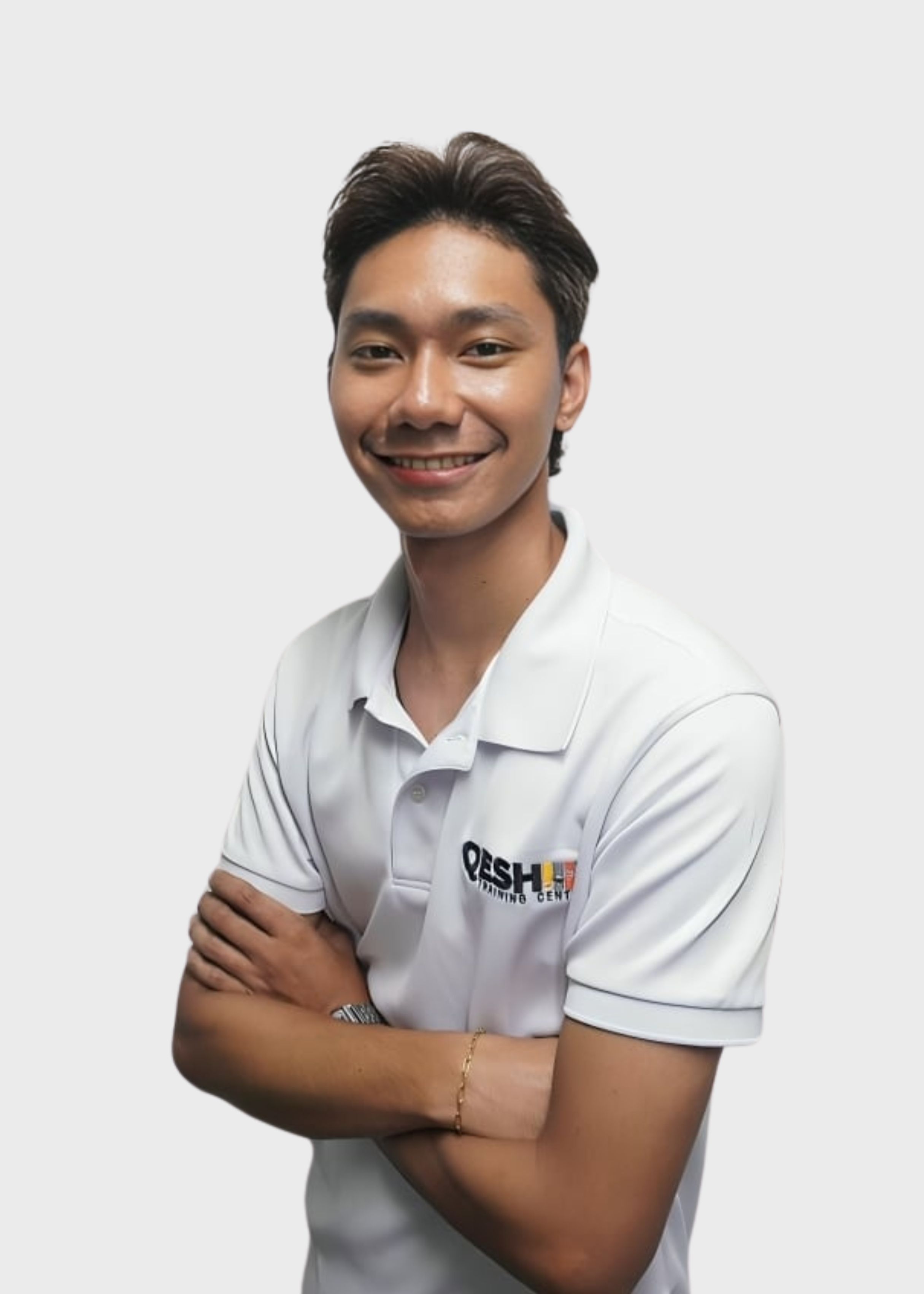 Smiling person in a white polo shirt with a lanyard