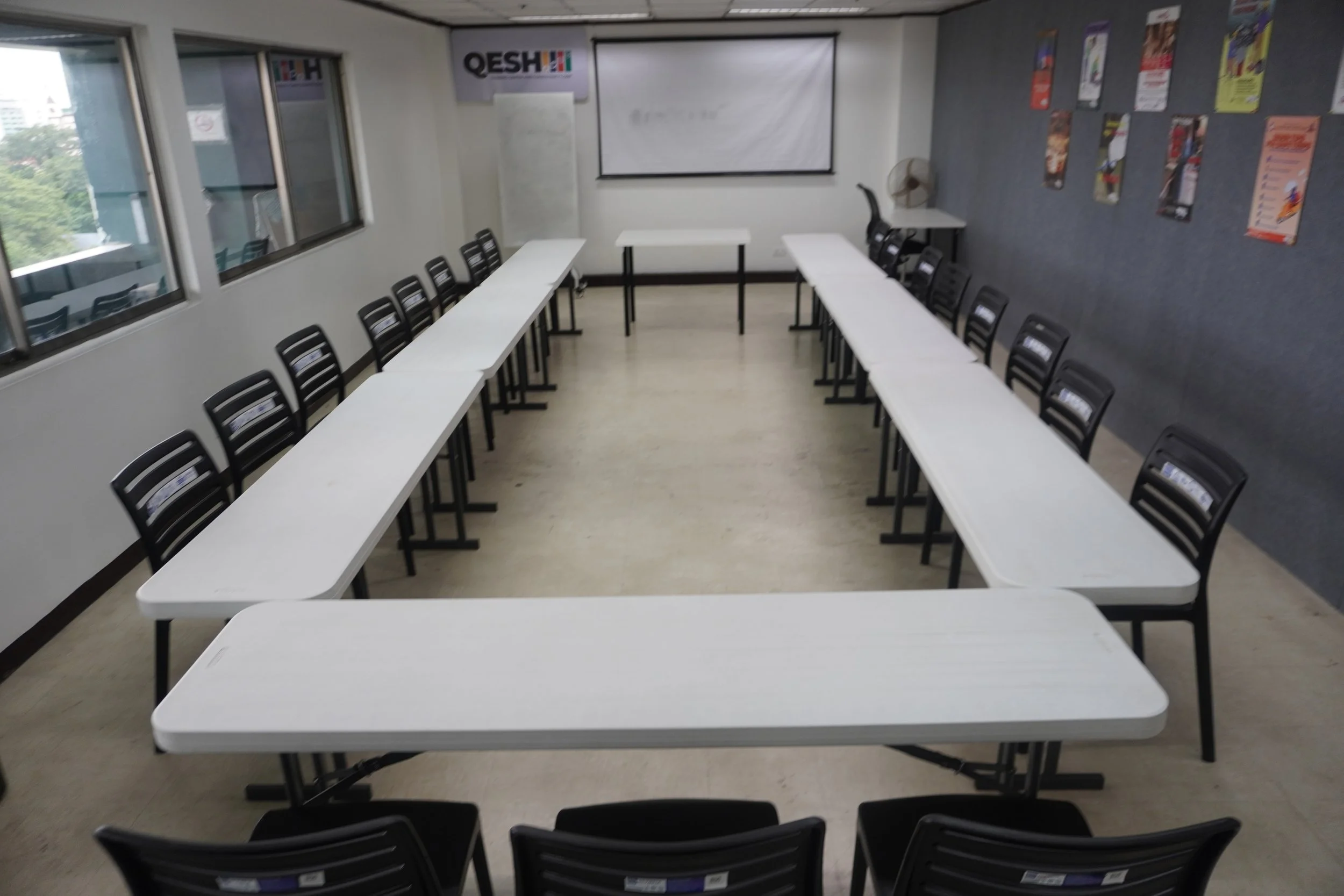 Conference room with U-shaped table arrangement and chairs