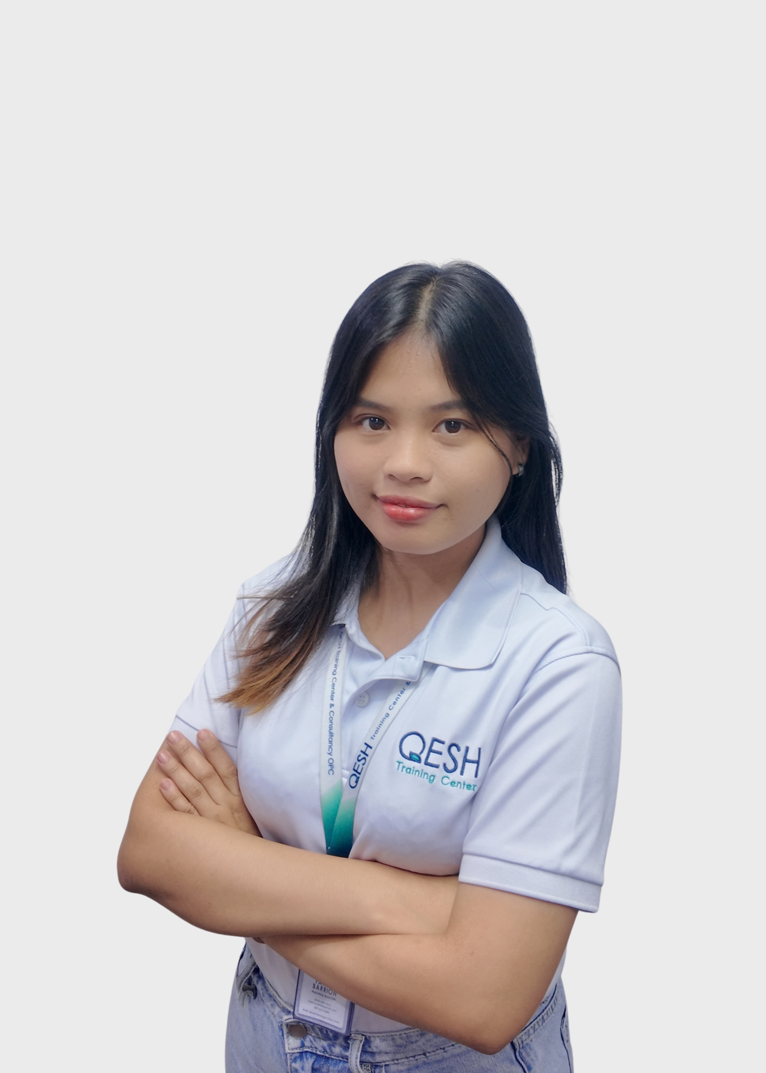 Person wearing a white polo shirt with "QESH Training Center" logo and a corresponding lanyard, standing against a plain background.