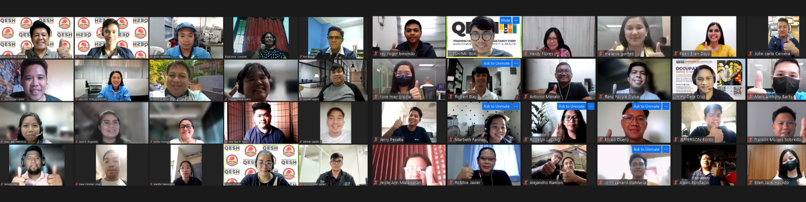 A virtual meeting with a grid of diverse participants, each in their own video window, some giving thumbs up.