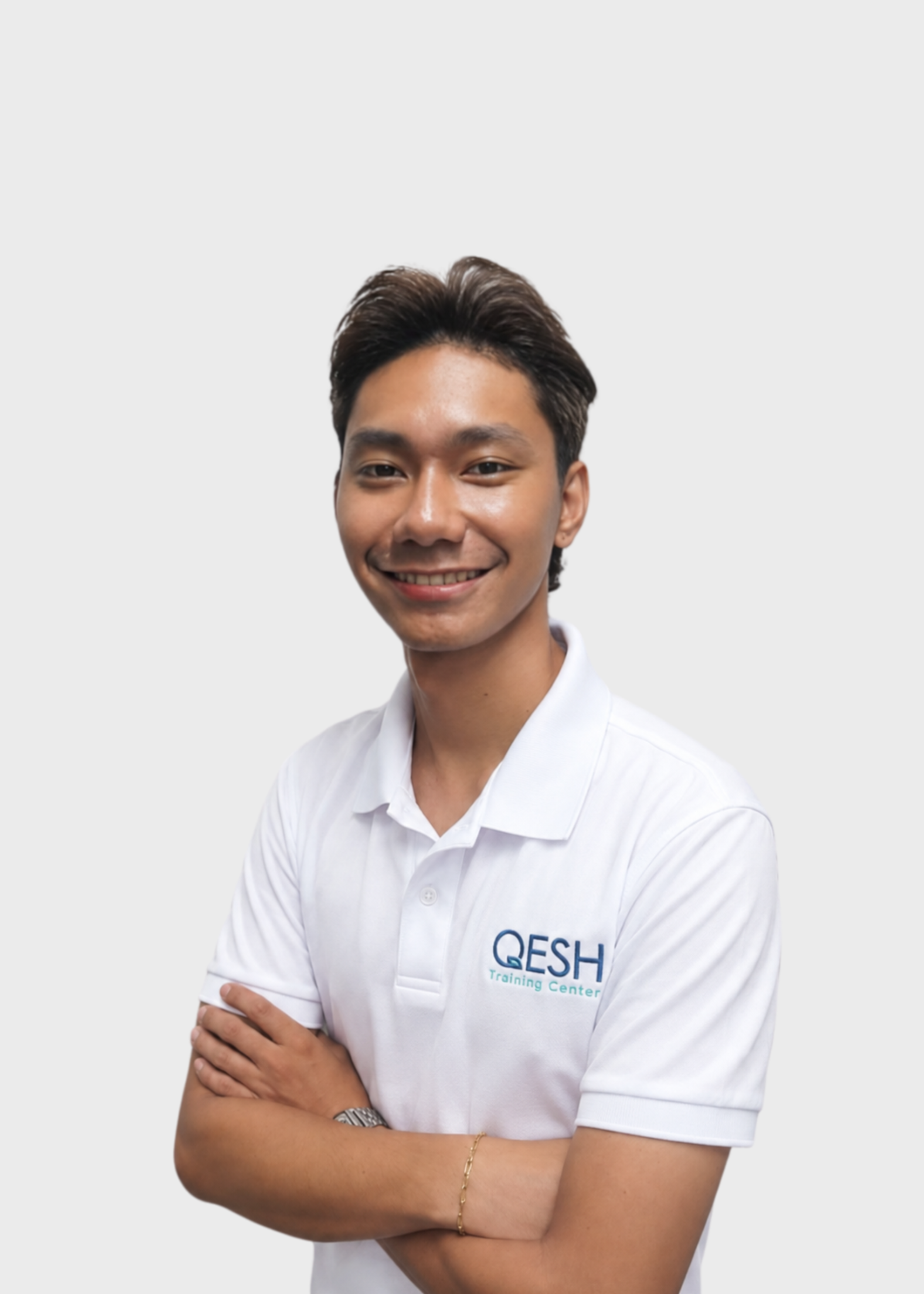 Smiling person in a white polo shirt with a lanyard