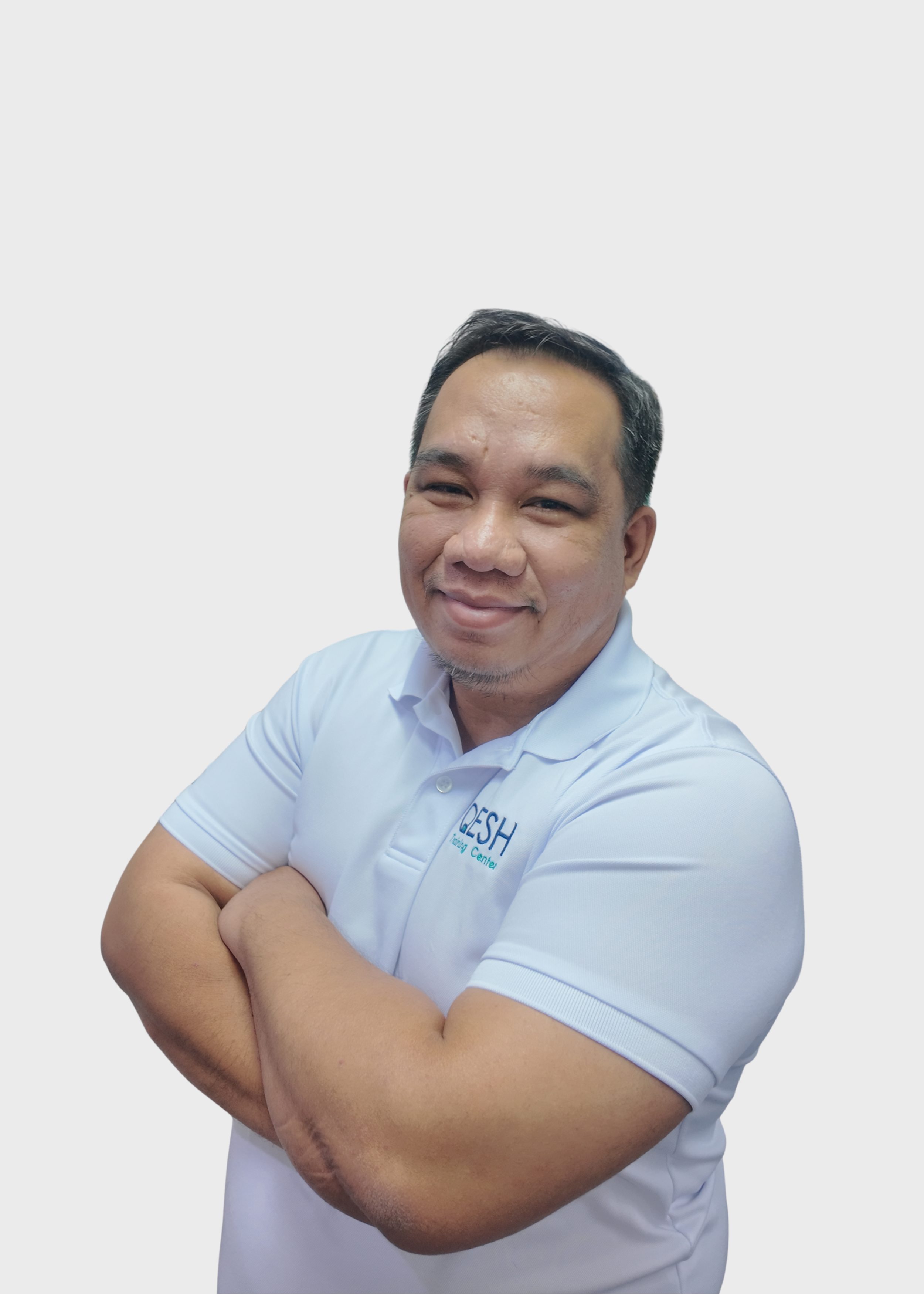 Man smiling with arms crossed, wearing a red, white, and blue polo shirt